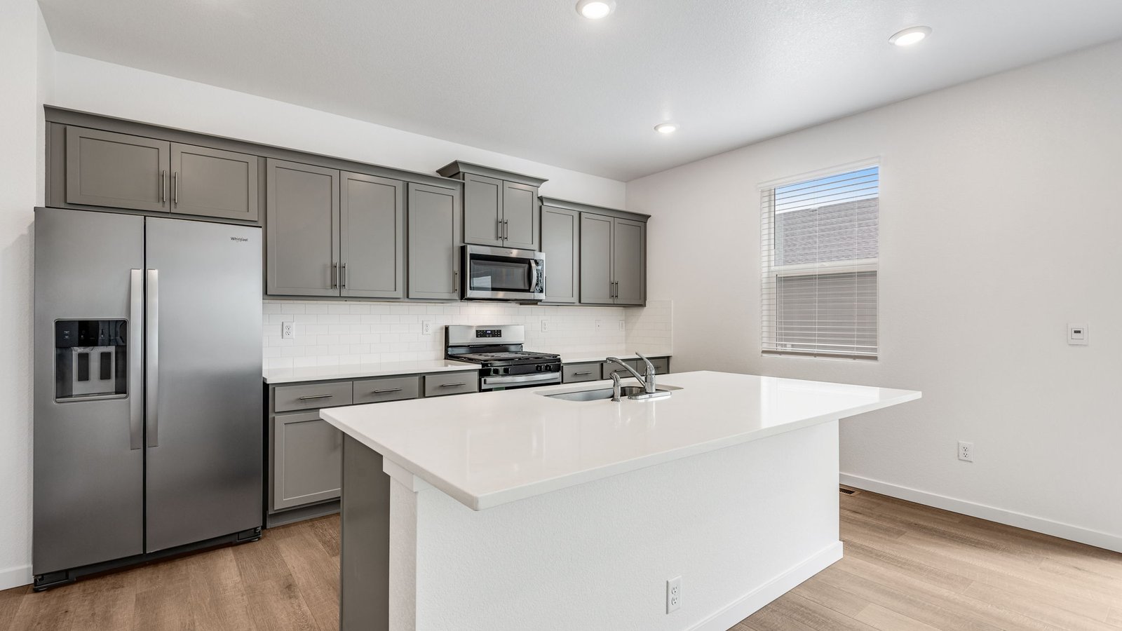 Spacious kitchen island great for entertaining in new home in Lochbuie Colorado