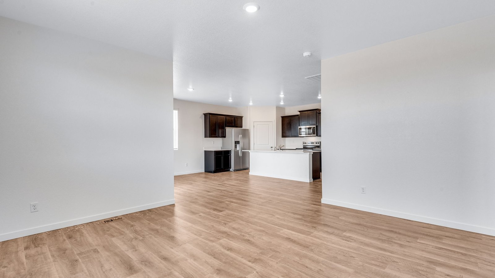 Spacious great room in the Chatham floor plan featuring an open-concept design and abundant natural light.