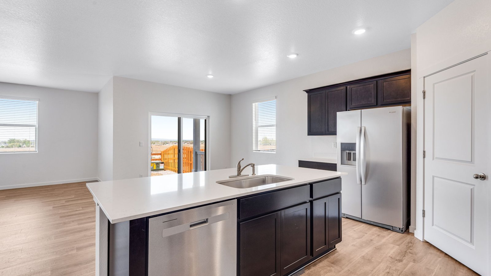 Bright kitchen in the Chatham ranch-style home showcasing stainless steel appliances and expansive counter space.