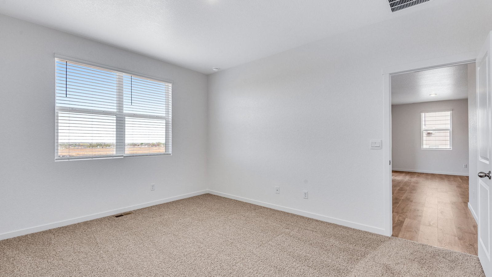 Primary bedroom in the Chatham floor plan at Fossil Creek Ranch in Windsor, CO featuring a spacious layout and natural light.