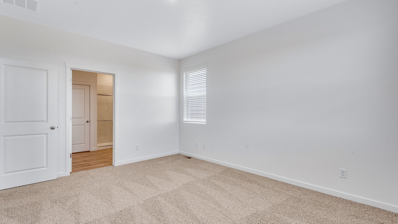 Owner's bedroom in the Chatham floor plan with ample space, large windows, and easy access to the private en-suite bathroom.