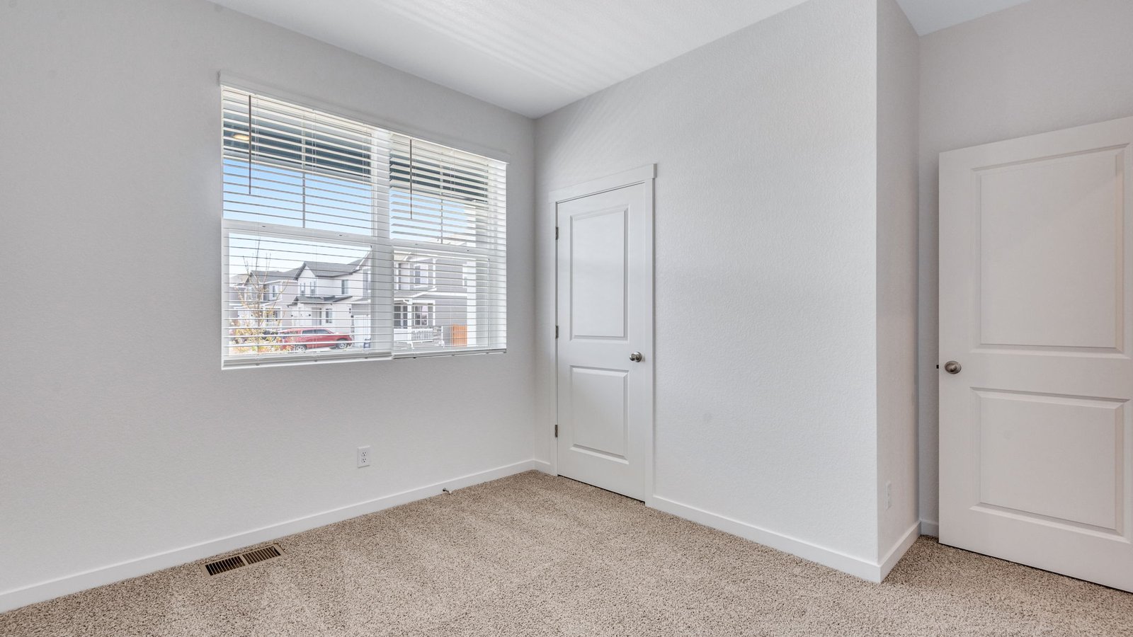 Spacious bedroom in the Chatham home ideal for family members, guests, or a home office.