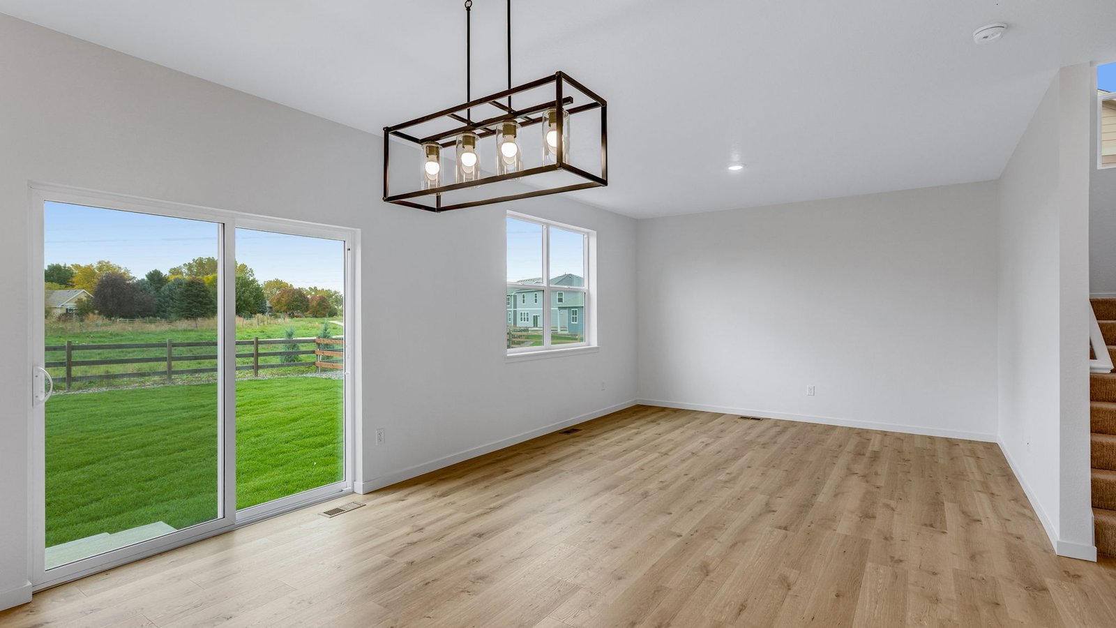 dining room with black modern chandelier in new windsor, co home