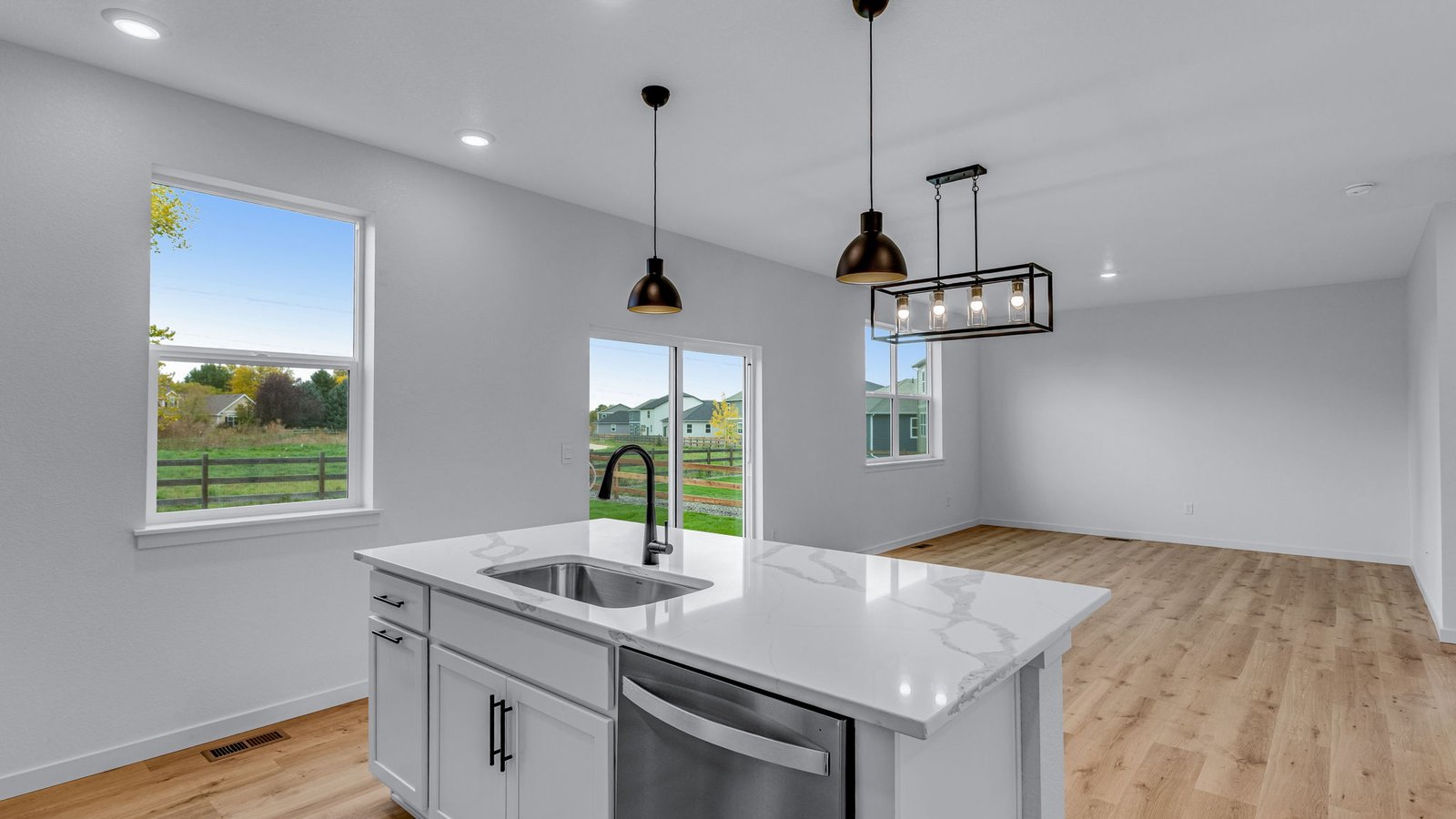 view from kitchen to living room in new construction home by d.r. horton