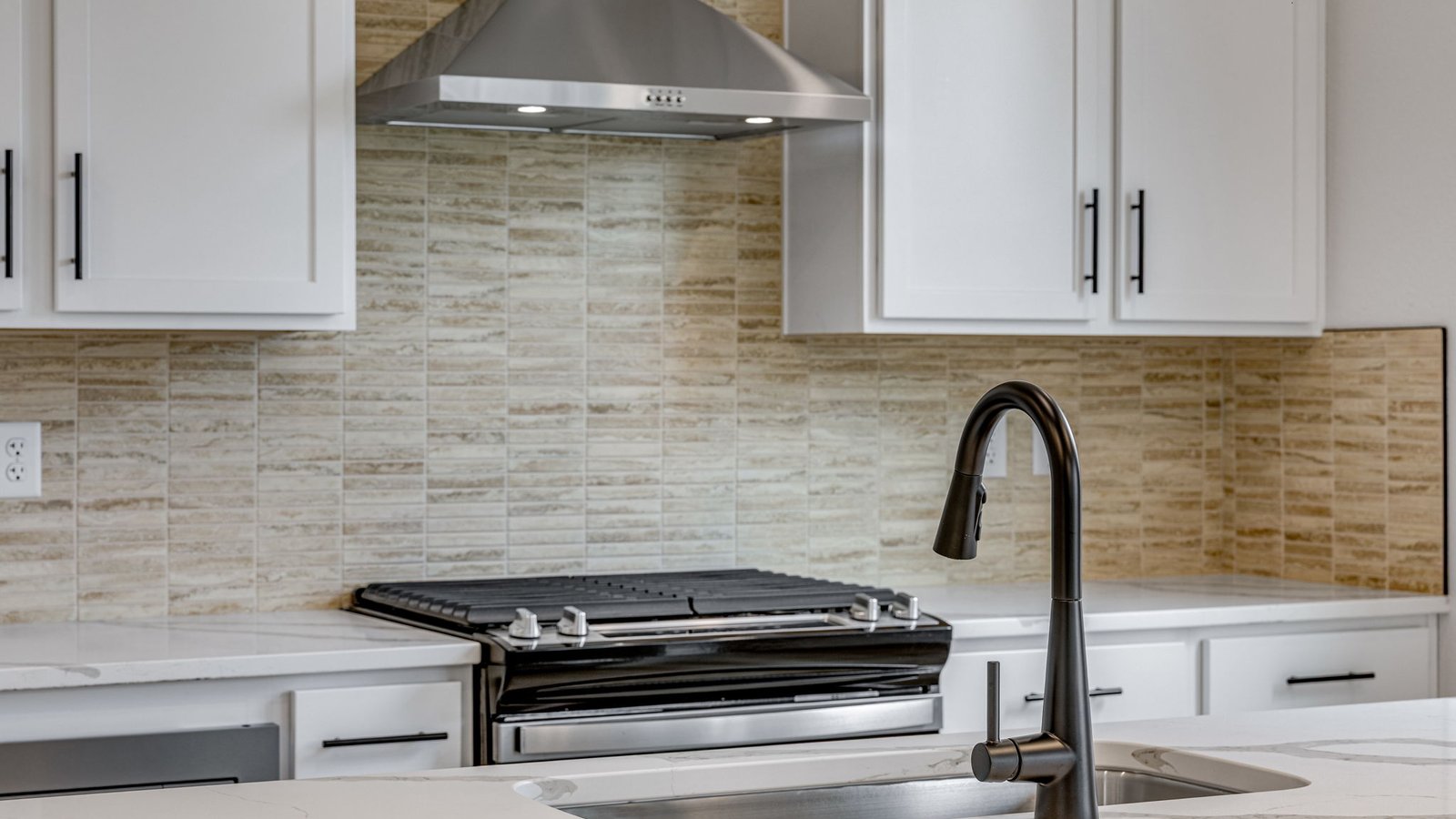 modern kitchen with black finishes in new construction home windsor, co