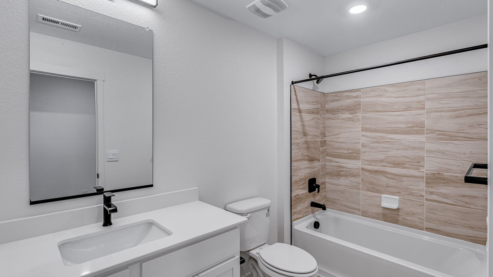 full bathroom with tub tile surround in new d.r. horton windsor home
