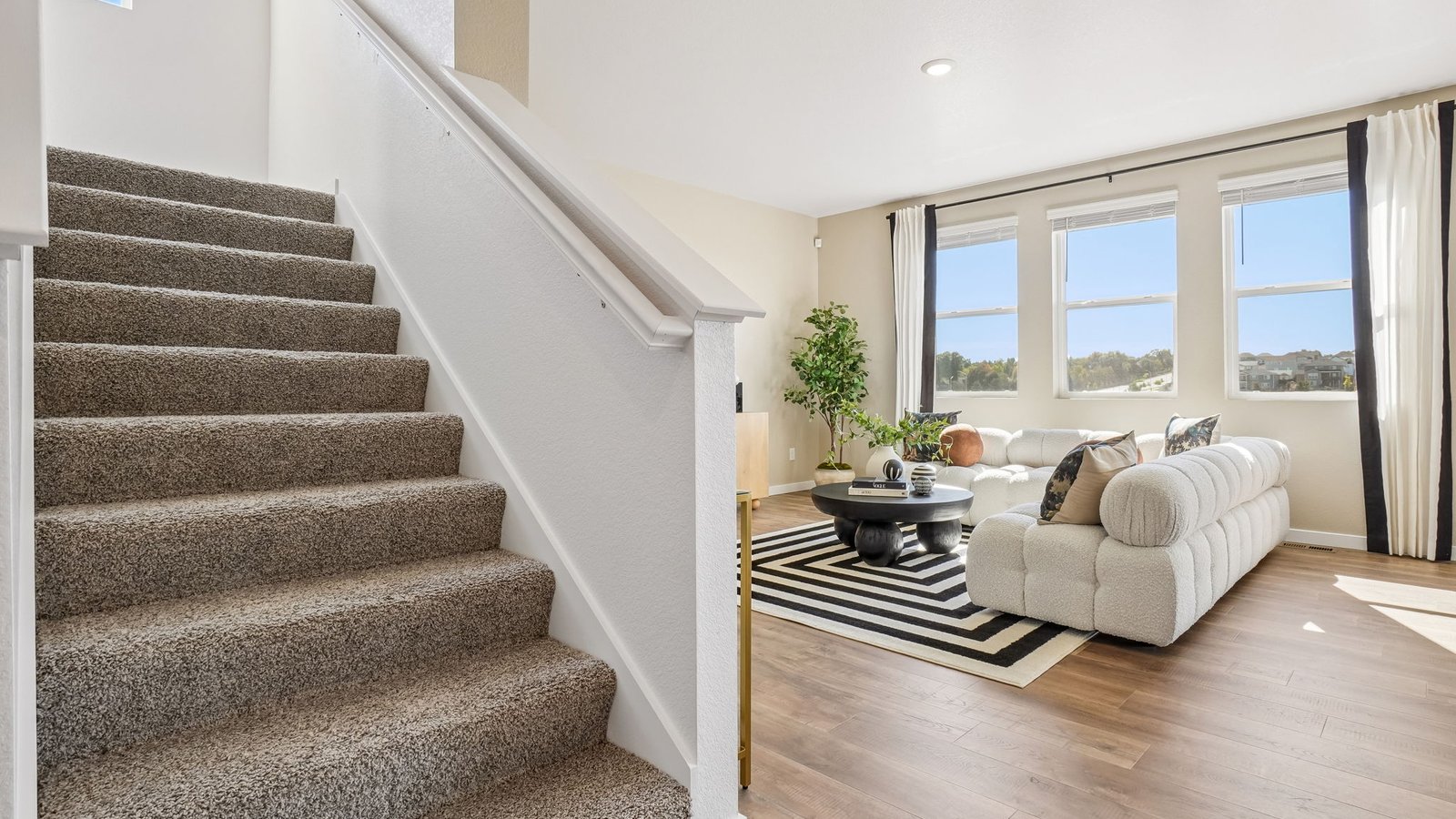 Spacious great room with abundant natural light and seamless flow into the kitchen and dining area.