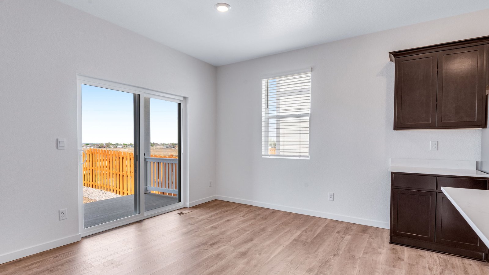 Dining room area with access to porch in new home at Lakeside Canyon