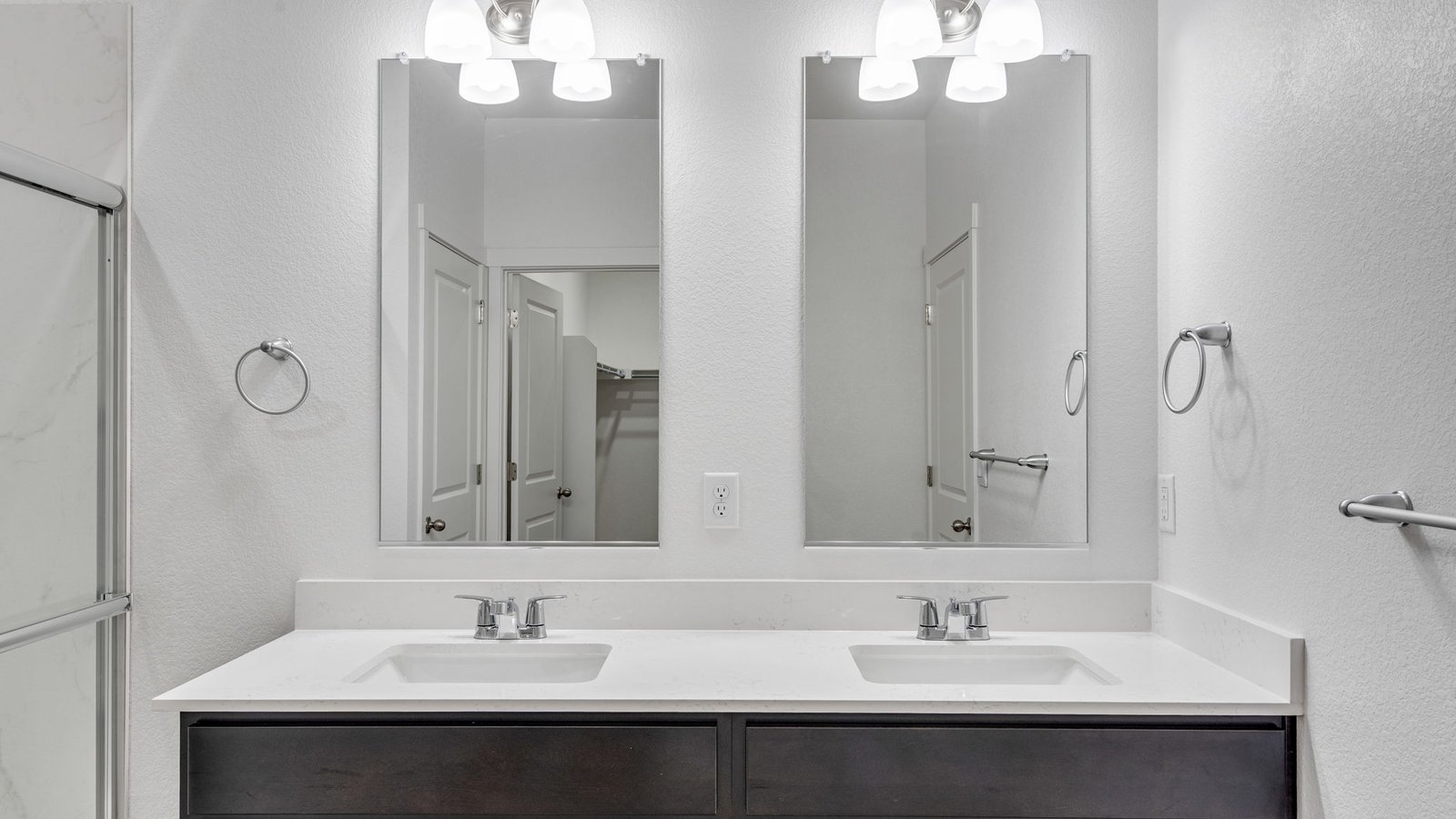 Attached private primary bathroom with dual vanity sinks in new home in Mead Colorado