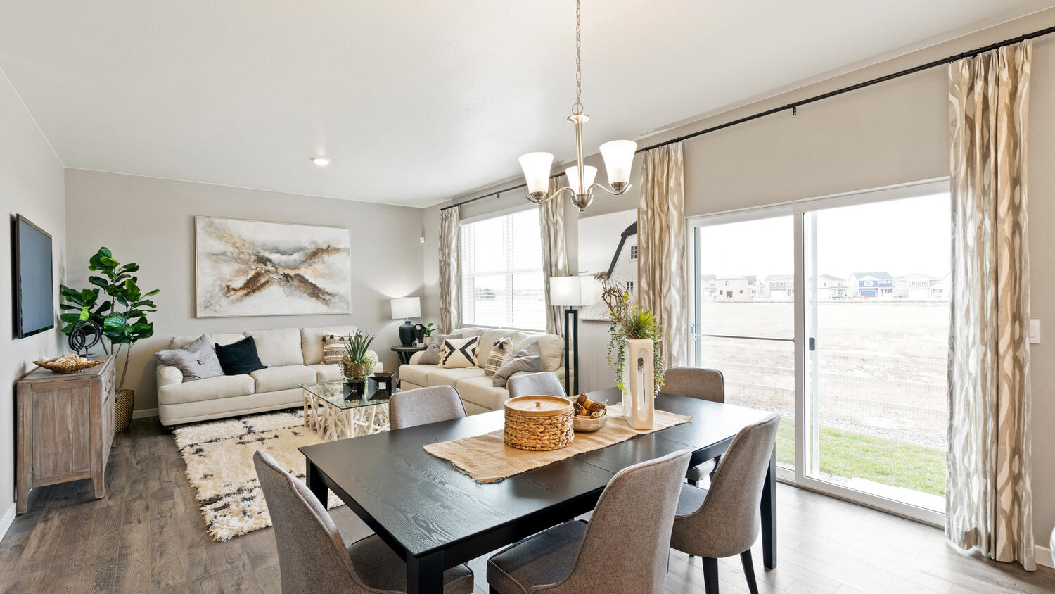 Open concept main floor layout with large windows in new D.R. Horton home in Mead, Colorado
