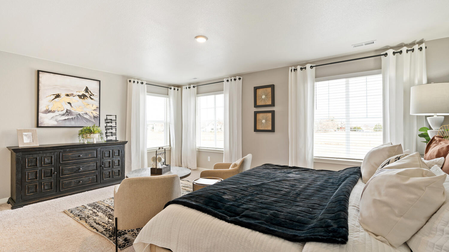 Primary bedroom with large windows in new D.R. Horton home in Mead, Colorado