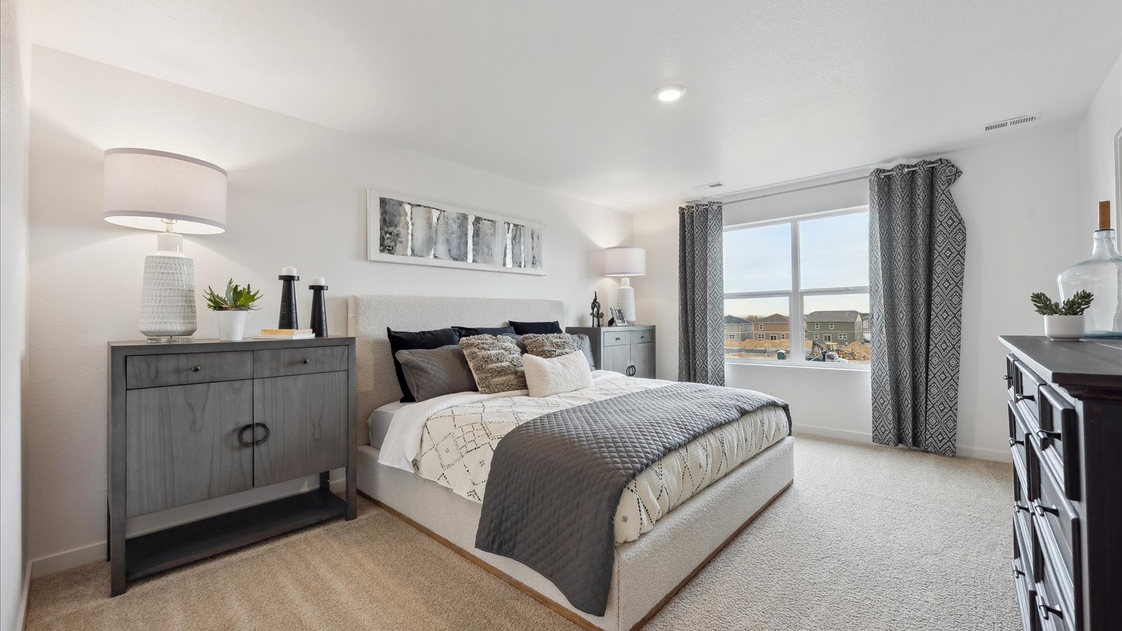 Primary bedroom with large windows in new D.R. Horton home