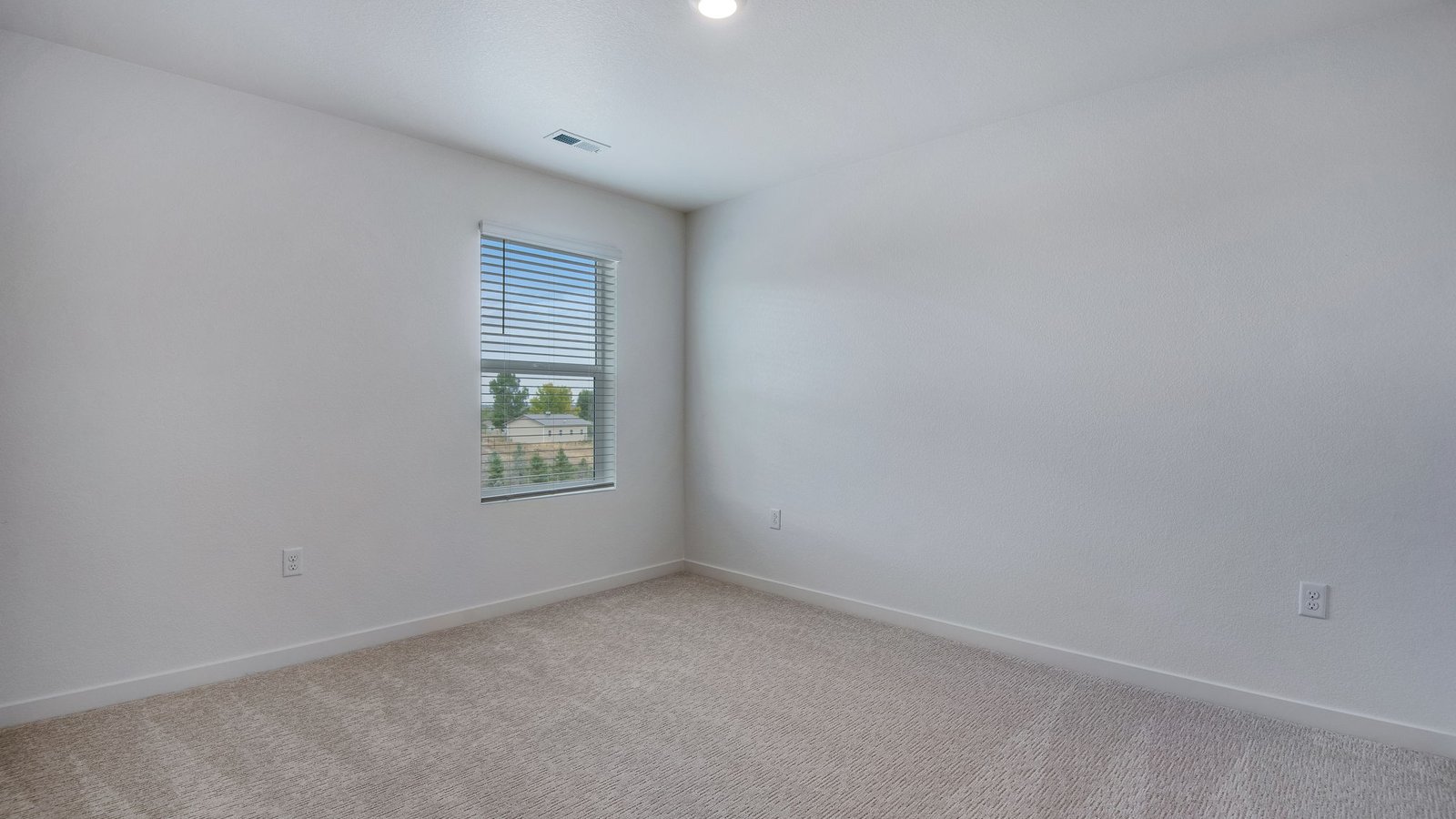 Secondary bedroom with natural light in new home in Mead Colorado