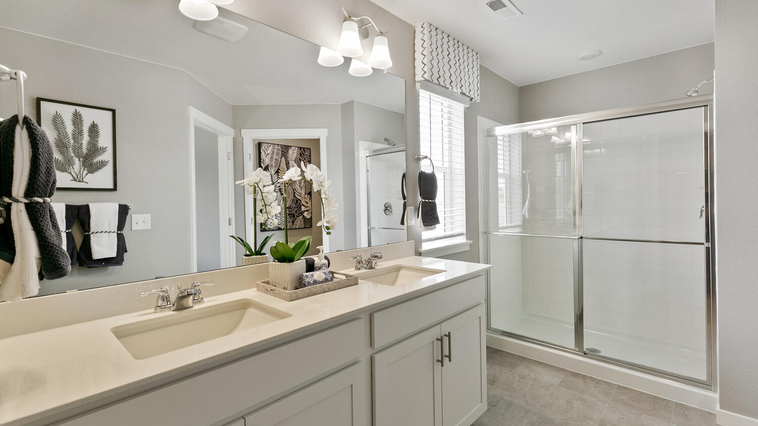 Primary bathroom with dual sink vanity in new home in Mead, Colorado