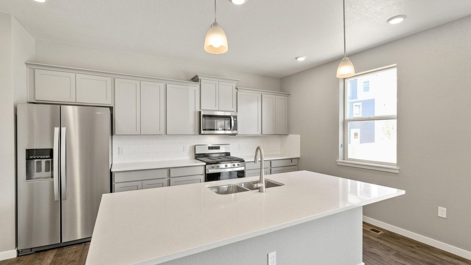 Spacious Kitchen with large windows in Bridgeport floorplan of Mead, CO new home