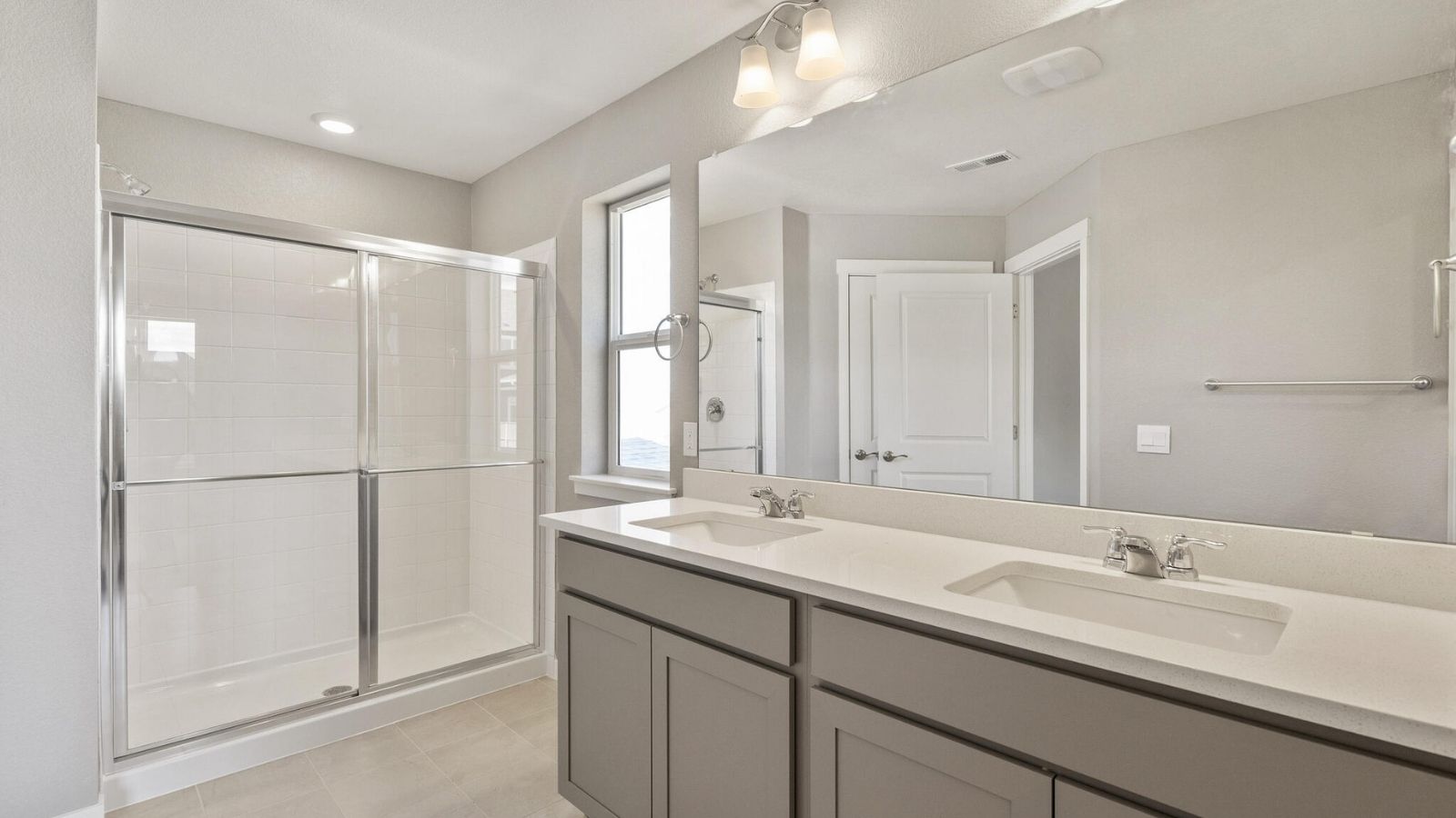Private primary bathroom with dual sink vanity in new home in Mead, CO