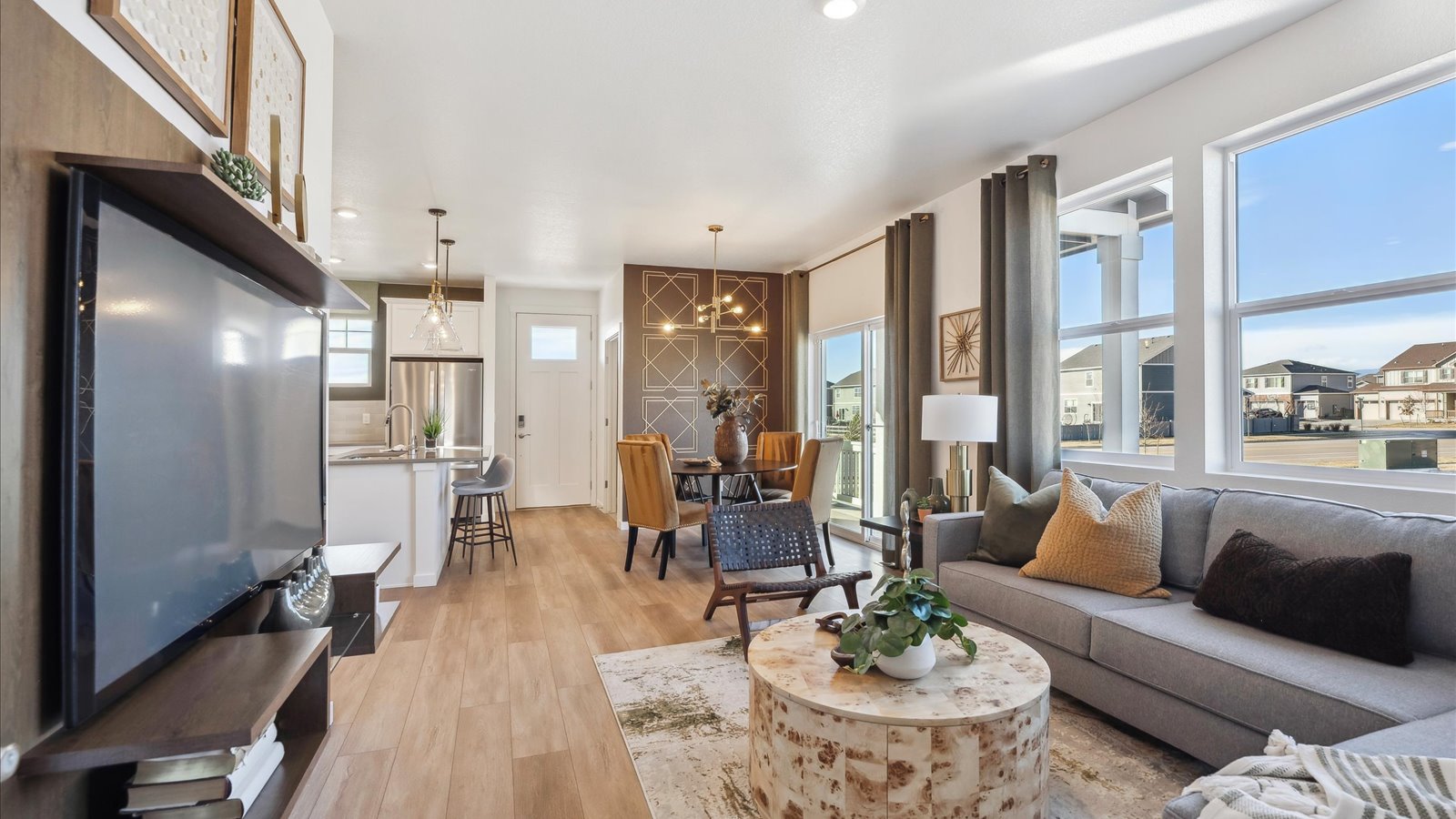 Open-concept great room in Muirfield plan with large windows and modern finishes