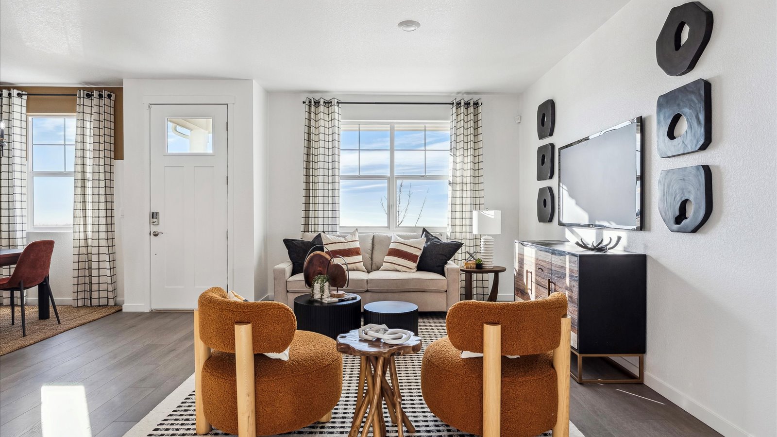 Open-concept great room in the Vail floor plan with abundant natural light, modern finishes, and seamless flow to the kitchen and dining area.