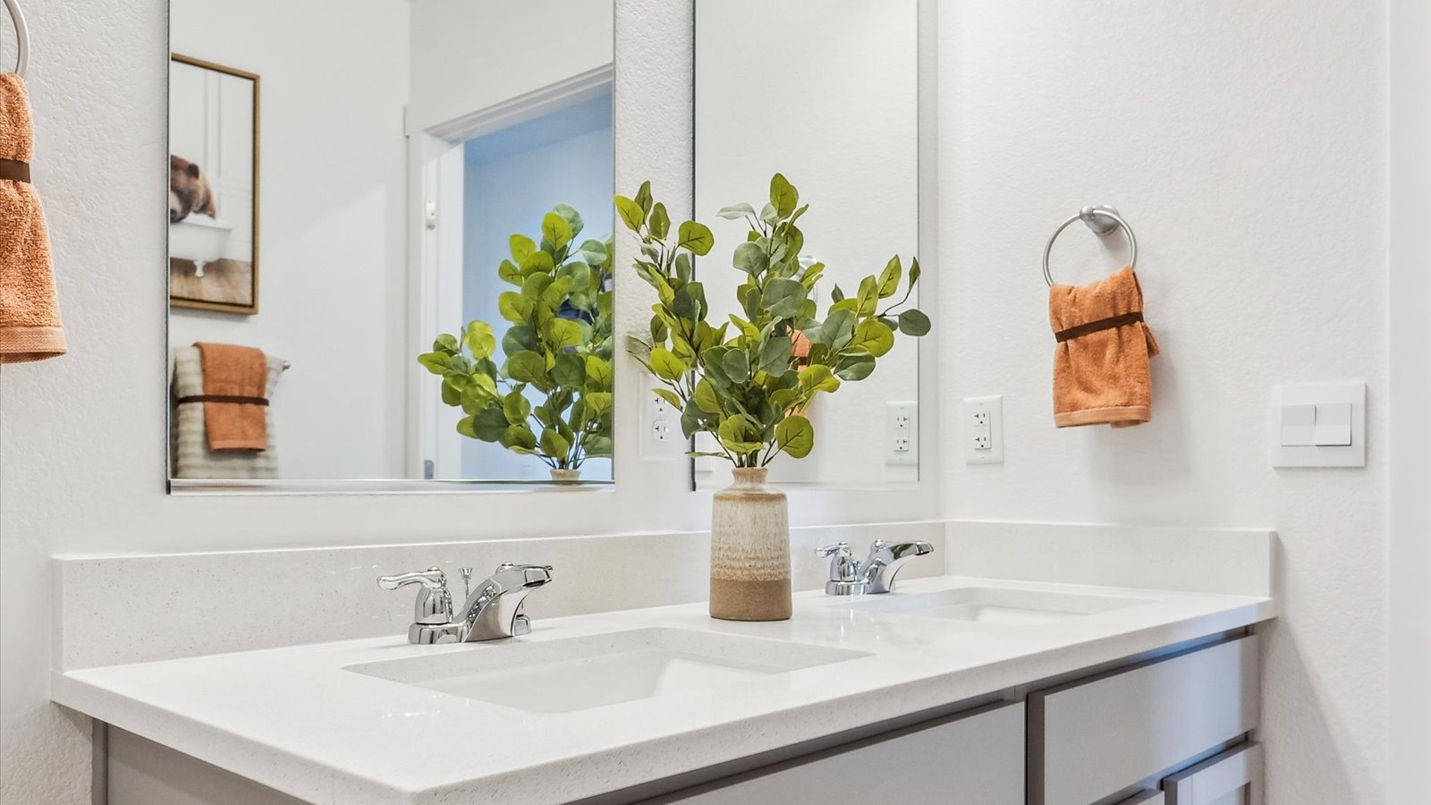 Stylish ensuite bathroom featuring dual sinks, contemporary finishes, and a spacious walk-in shower.
