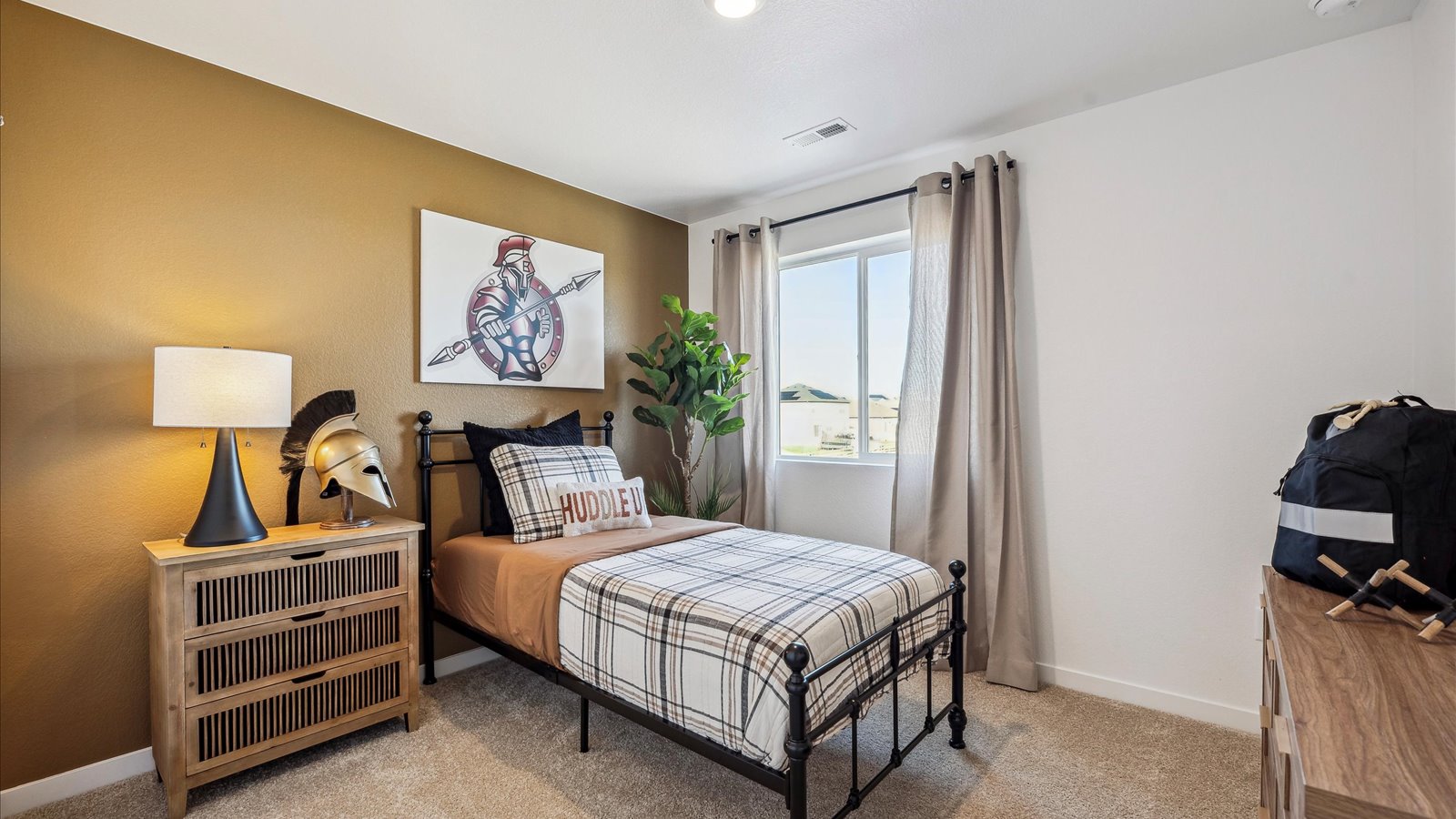 Comfortable upstairs bedroom featuring modern finishes and a spacious closet.