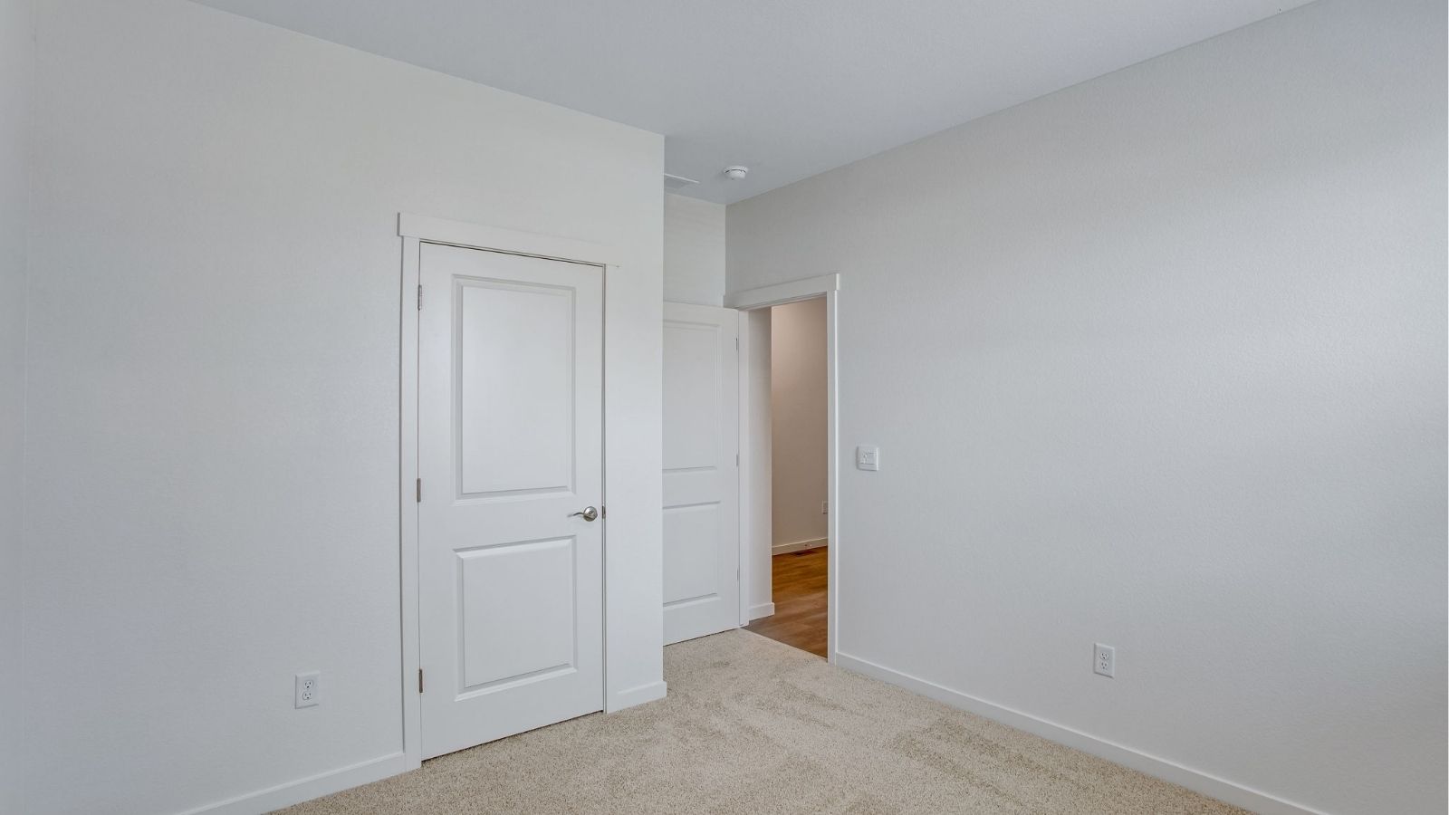 Versatile secondary bedroom with natural light and convenient access to the full bathroom.