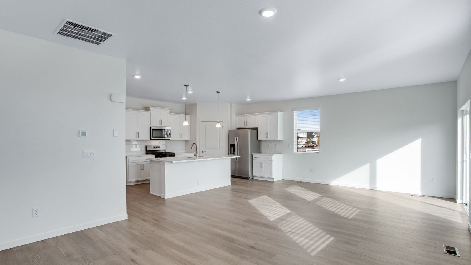 Bright Newcastle kitchen showcasing ample counter space, sleek finishes, and seamless flow into the dining area.