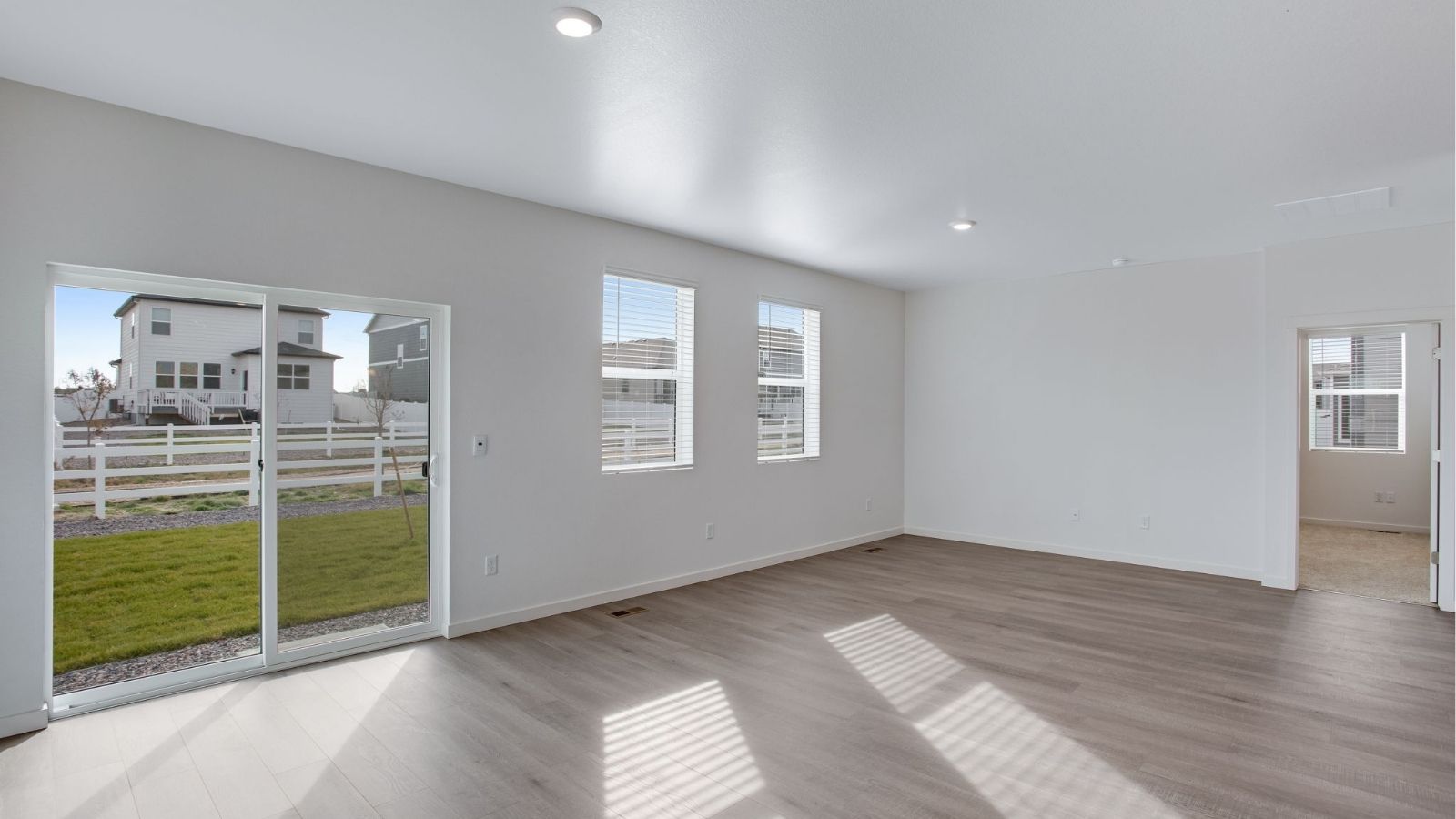 Spacious living room in the Newcastle floor plan featuring an open layout and abundant natural light.