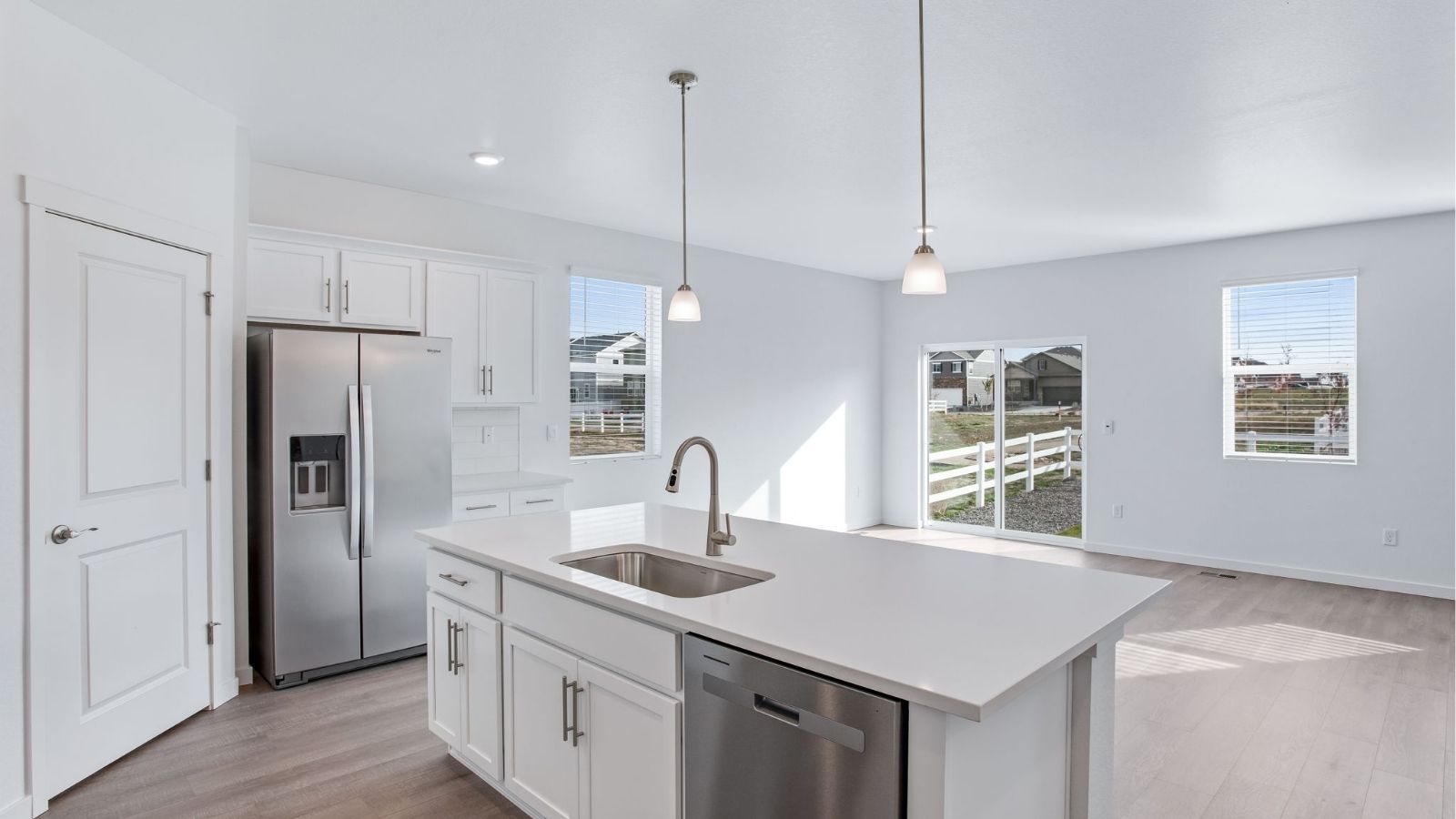 Open-concept kitchen in the Newcastle floor plan with contemporary cabinetry, a spacious pantry, and large center island.