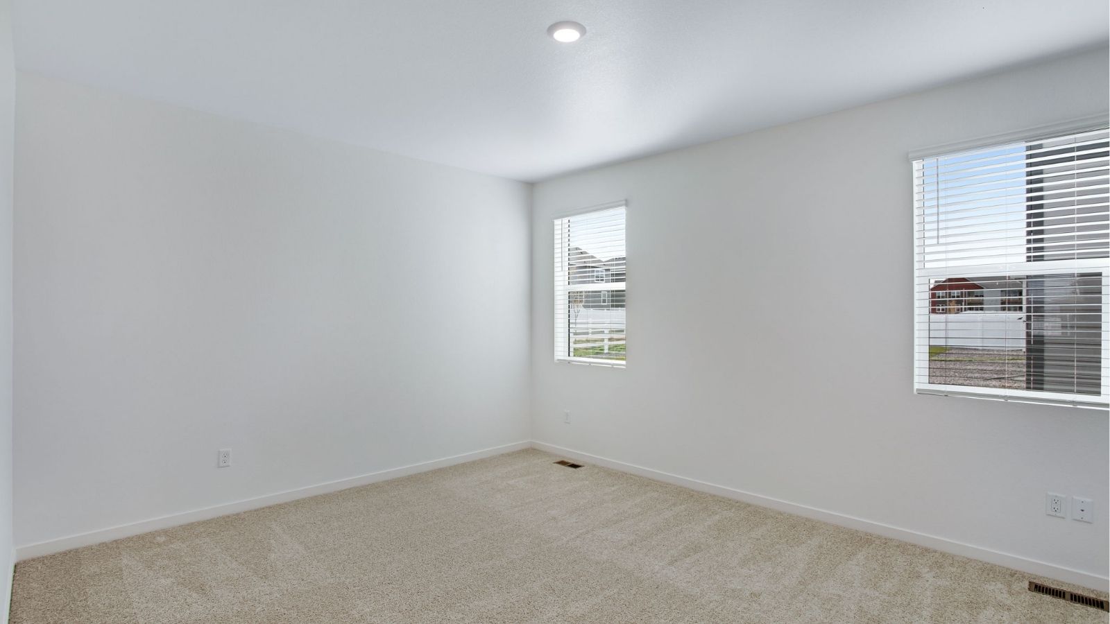 Relaxing primary bedroom in the Newcastle home with ample natural light and a luxurious ensuite bathroom.