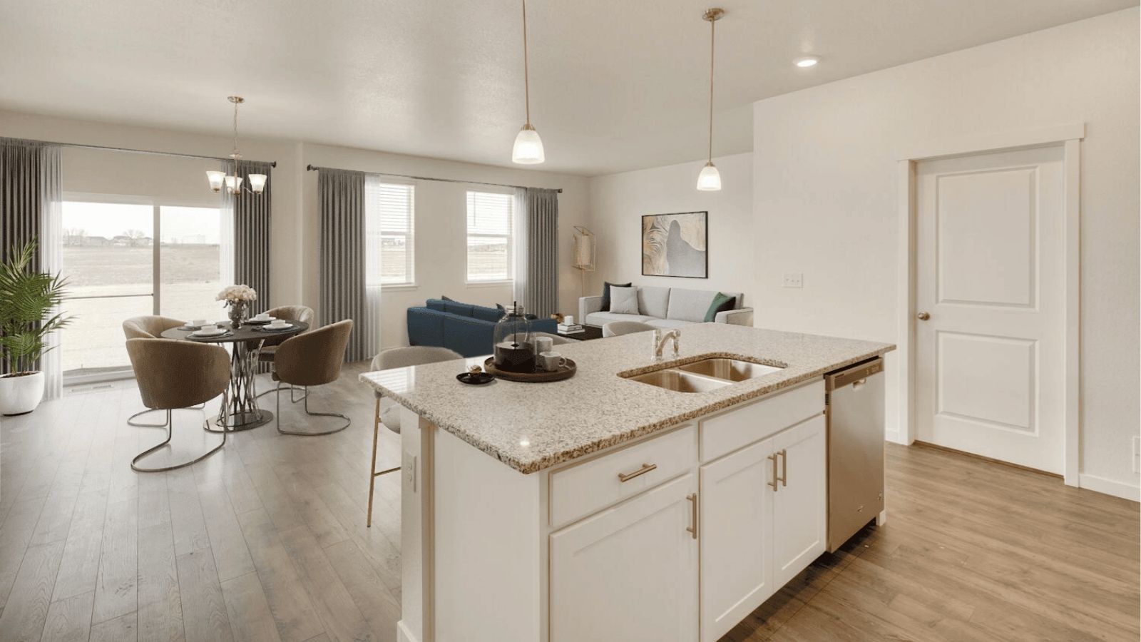 Open-concept kitchen in the Newcastle floor plan with contemporary cabinetry, a spacious pantry, and large center island.