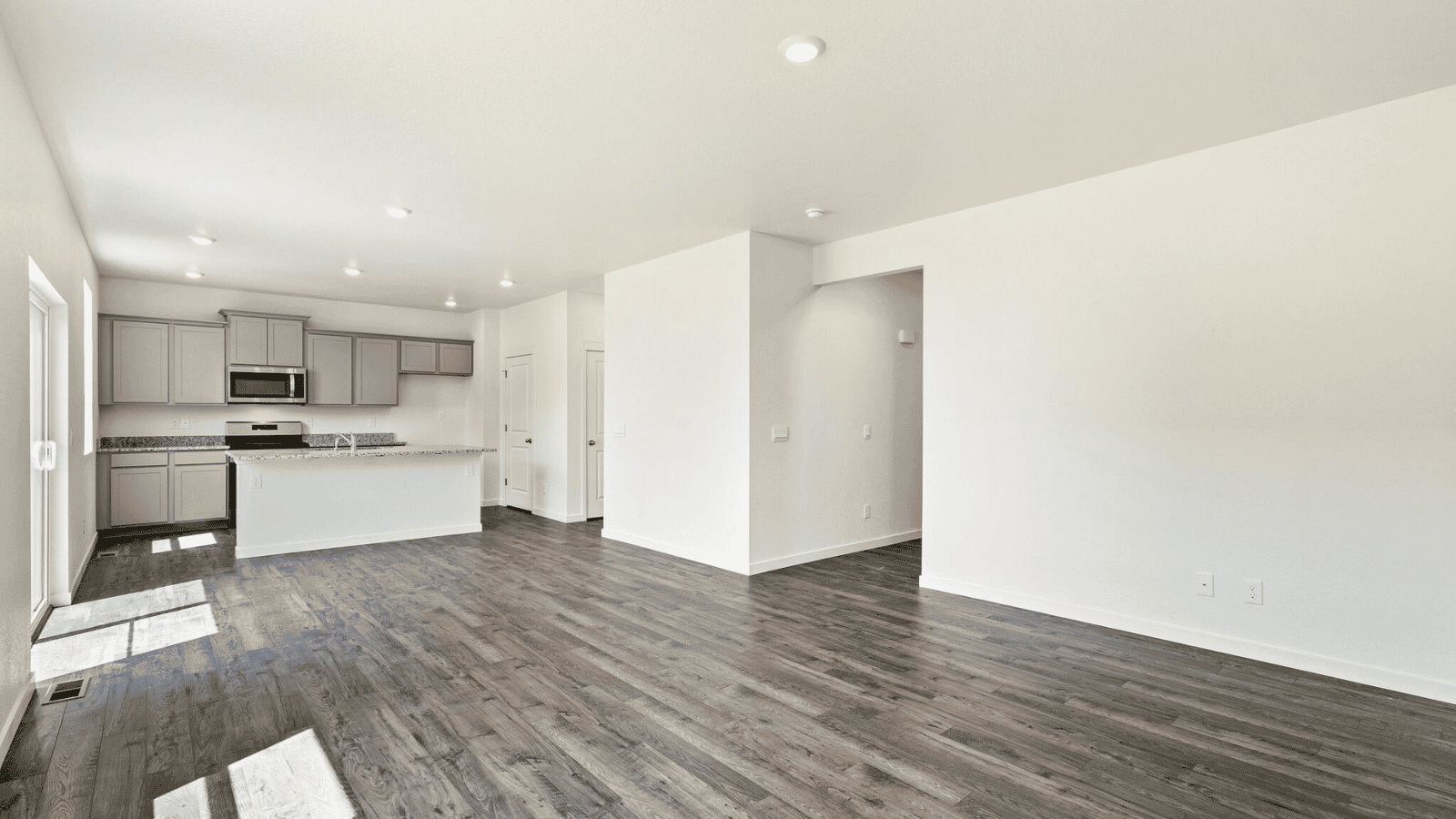 Open-concept great room in the Sienna floor plan featuring large windows and abundant natural light.