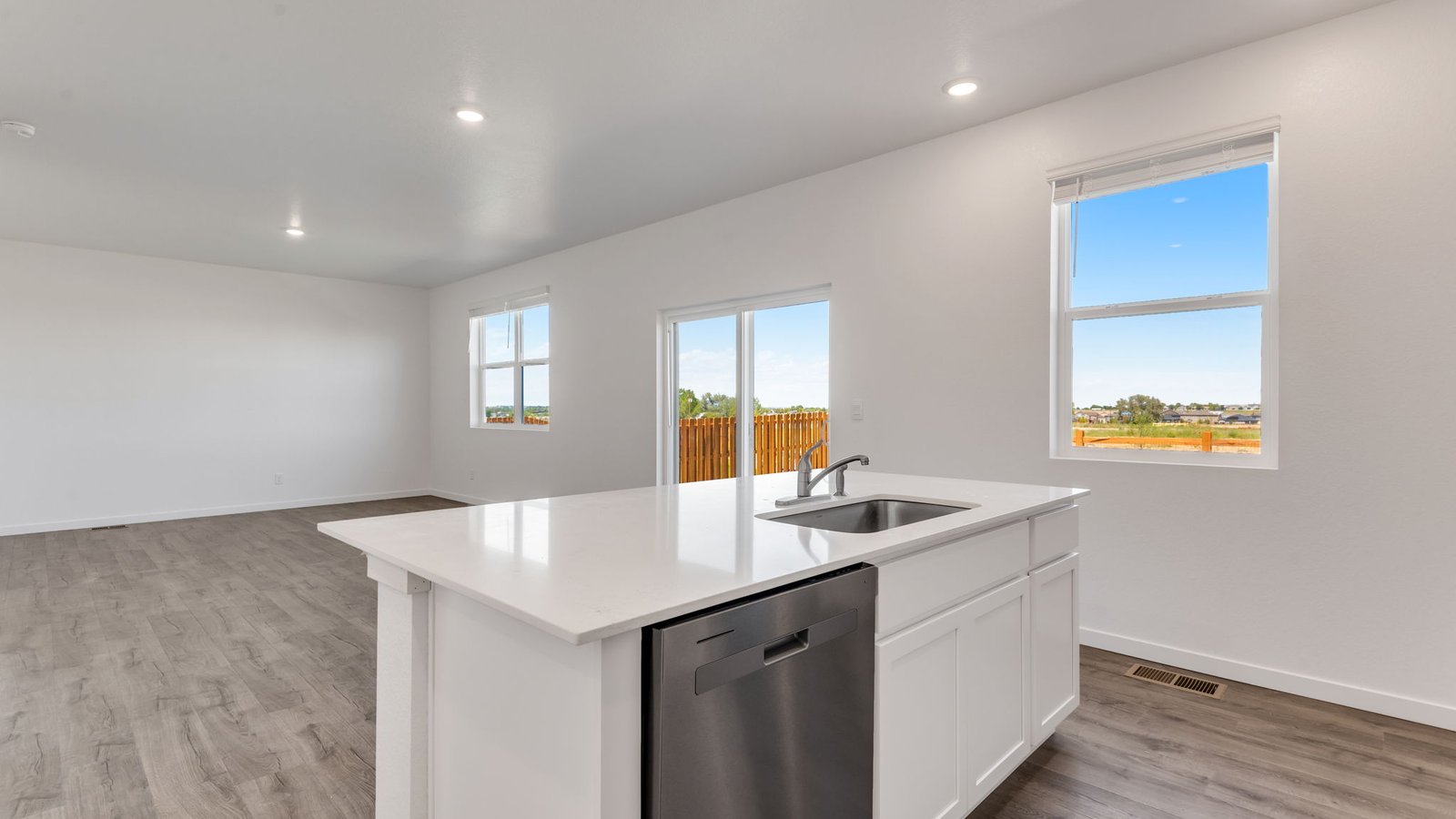 Open family room with modern finishes, natural light, and seamless flow for entertaining.