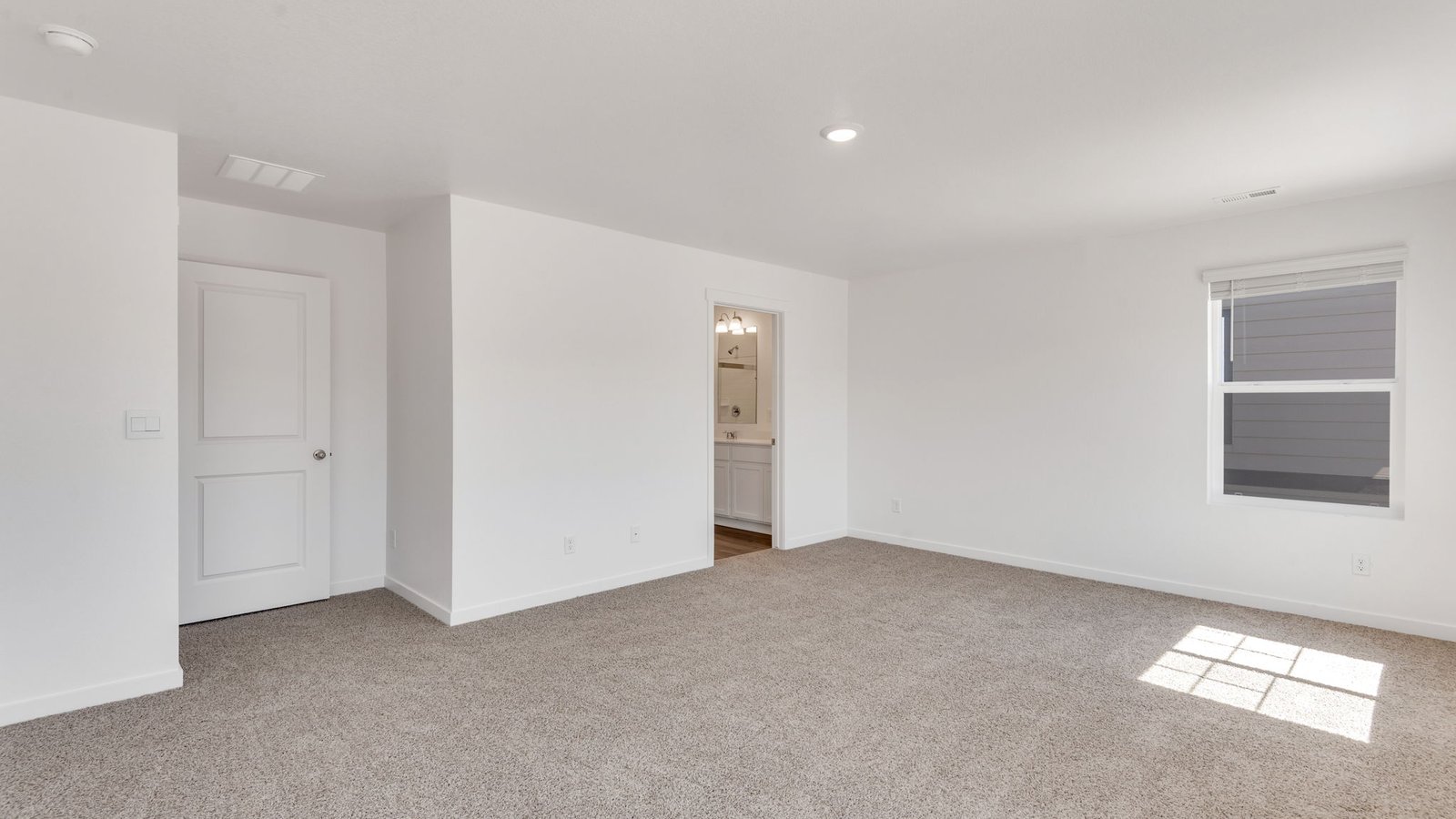 Bright owner's suite featuring modern finishes and ample space for furnishings.