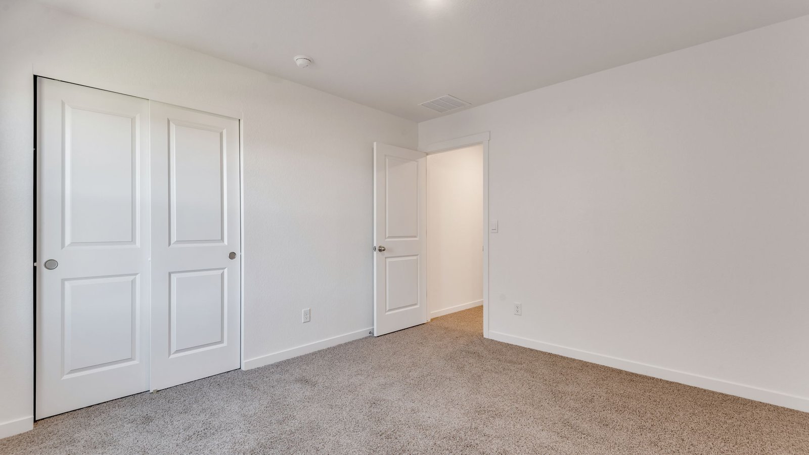 Comfortable upstairs bedroom with ample closet space and natural light.