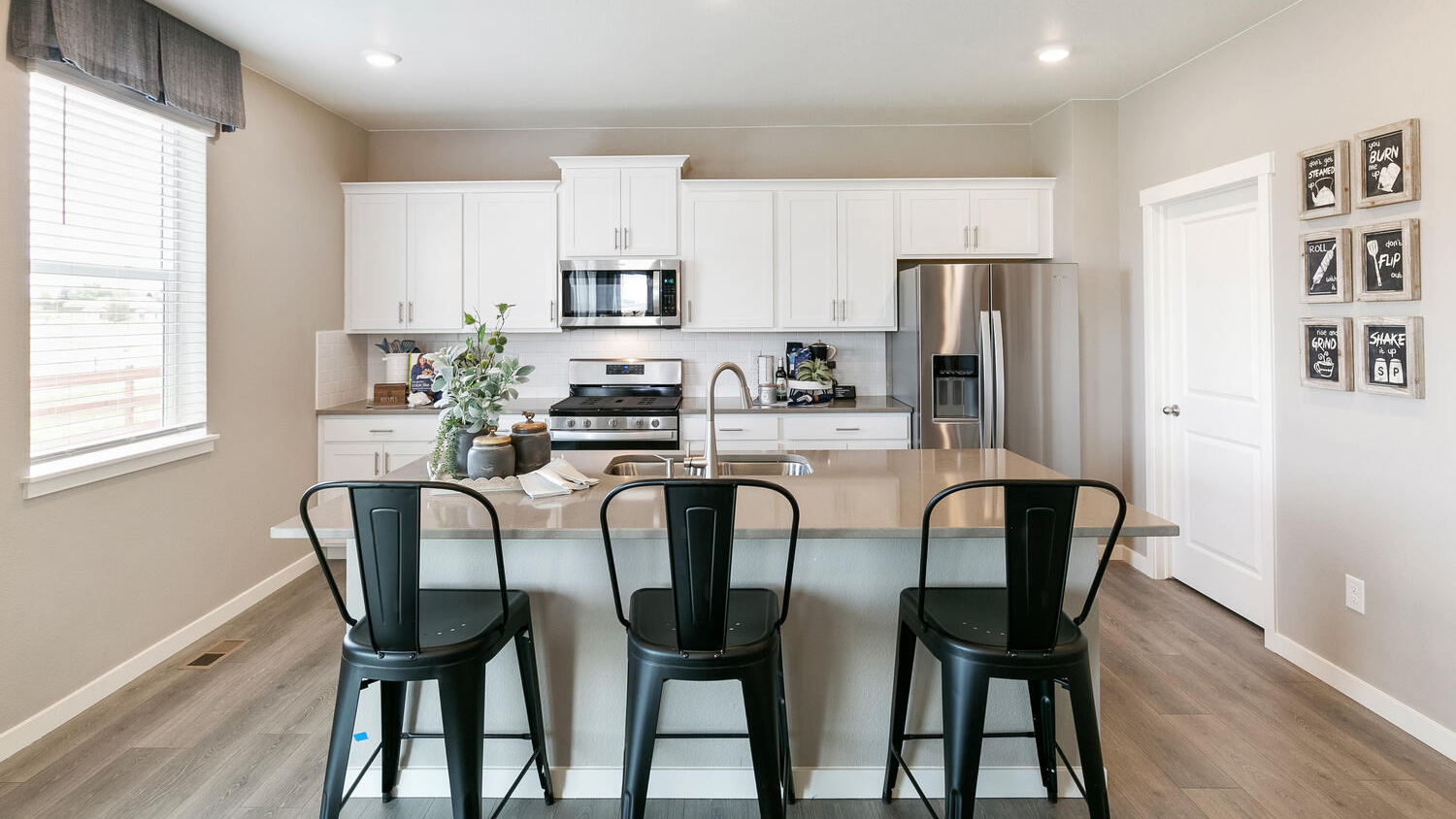 Spacious kitchen with granite or quartz countertops, abundant cabinetry, and an oversized island for gathering and meal preparation.