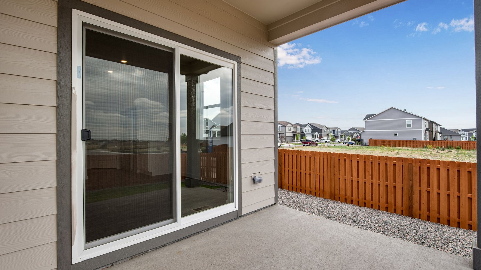 sliding glass door to back patio of new construction fort lupton home