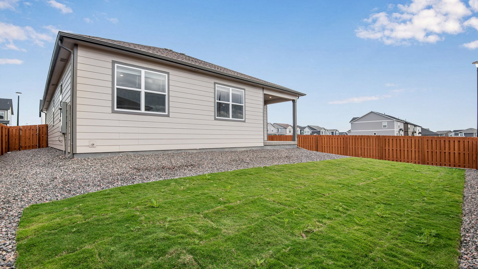 back yard with grass and privacy fence of new home in fort lupton, co