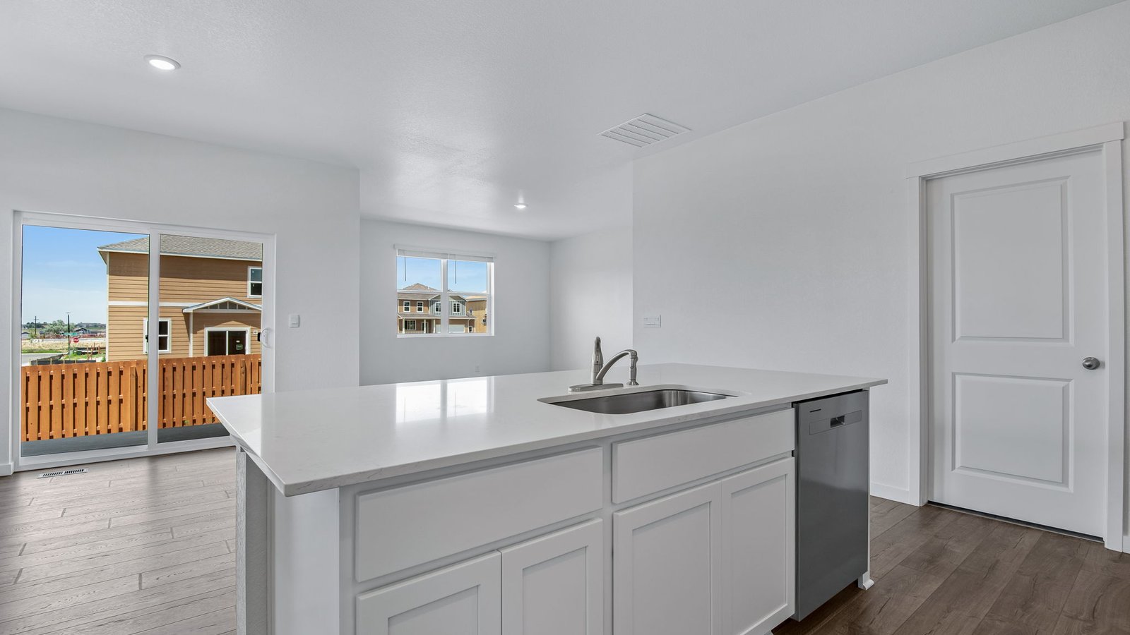 view from kitchen to living room of new construction home by d.r. horton