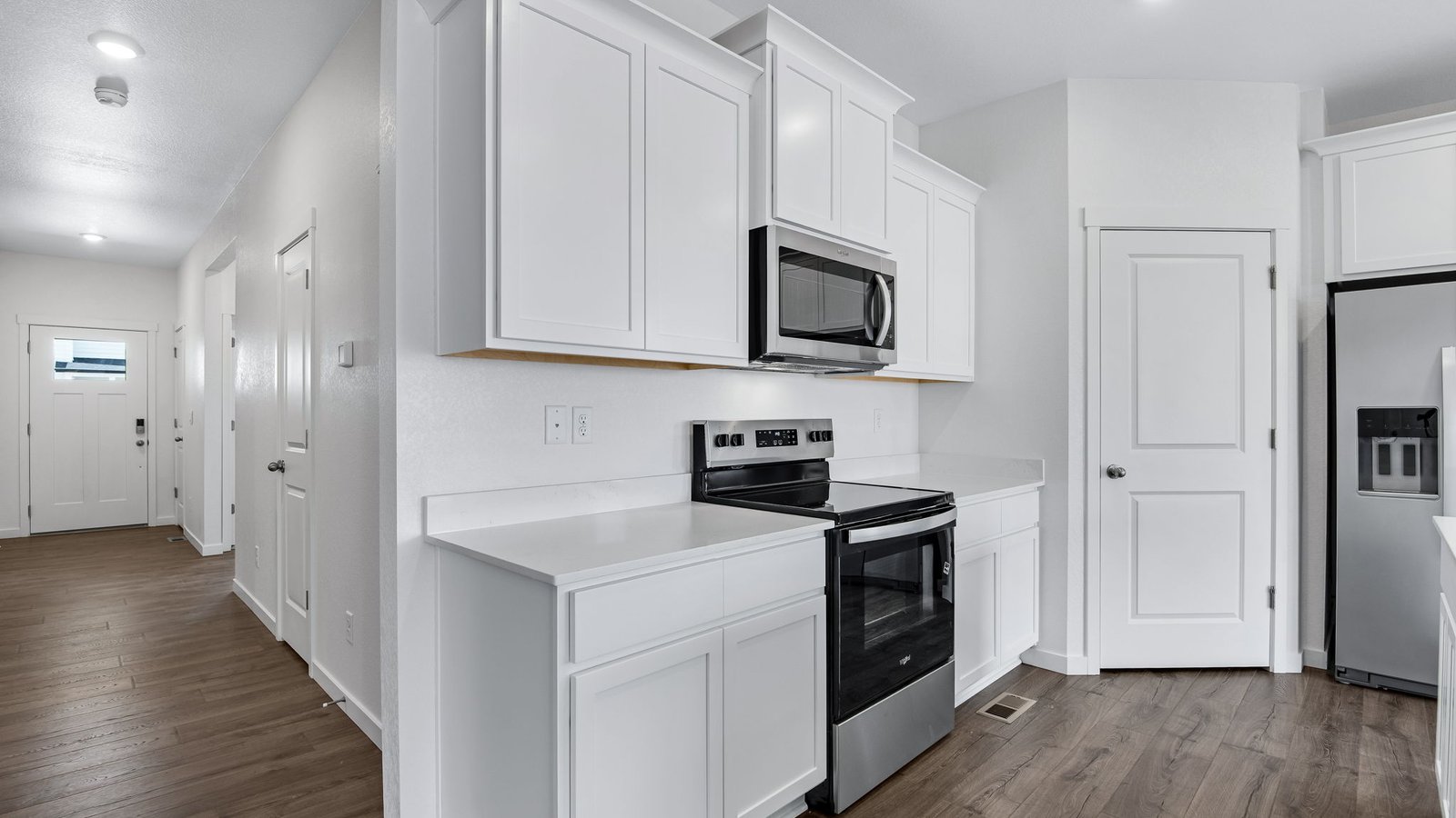 kitchen with white cabinets in new fort lupton home