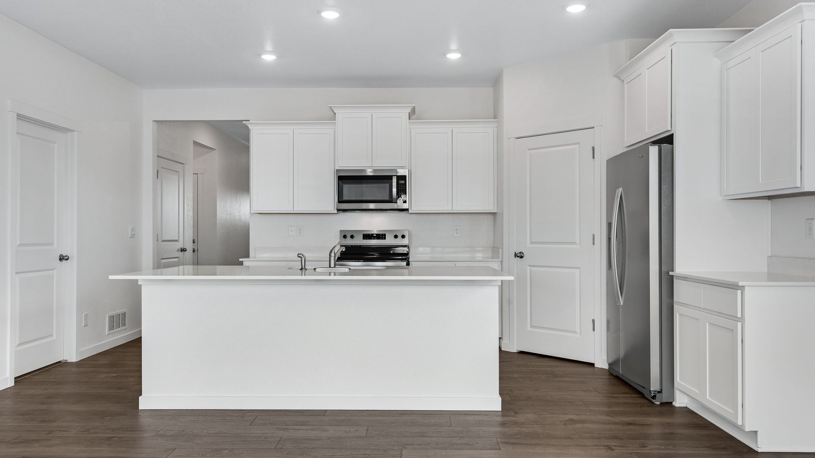 modern kitchen with white cabinets in new construciton home fort lupton, co