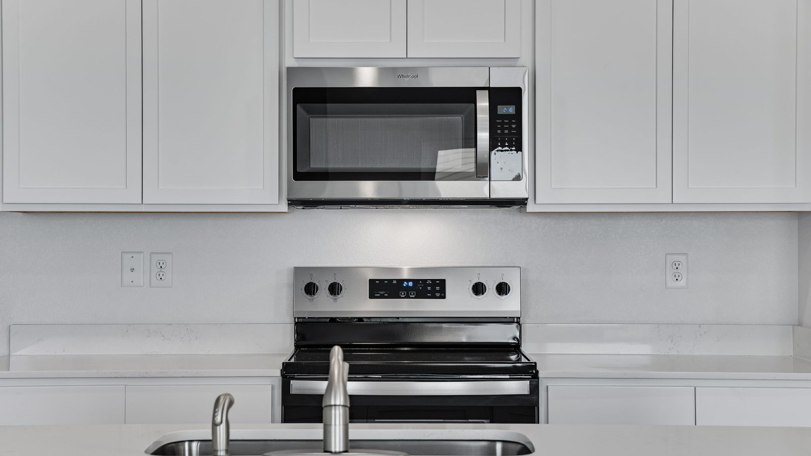 modern kitchen with stainless steel appliances in new fort lupton home