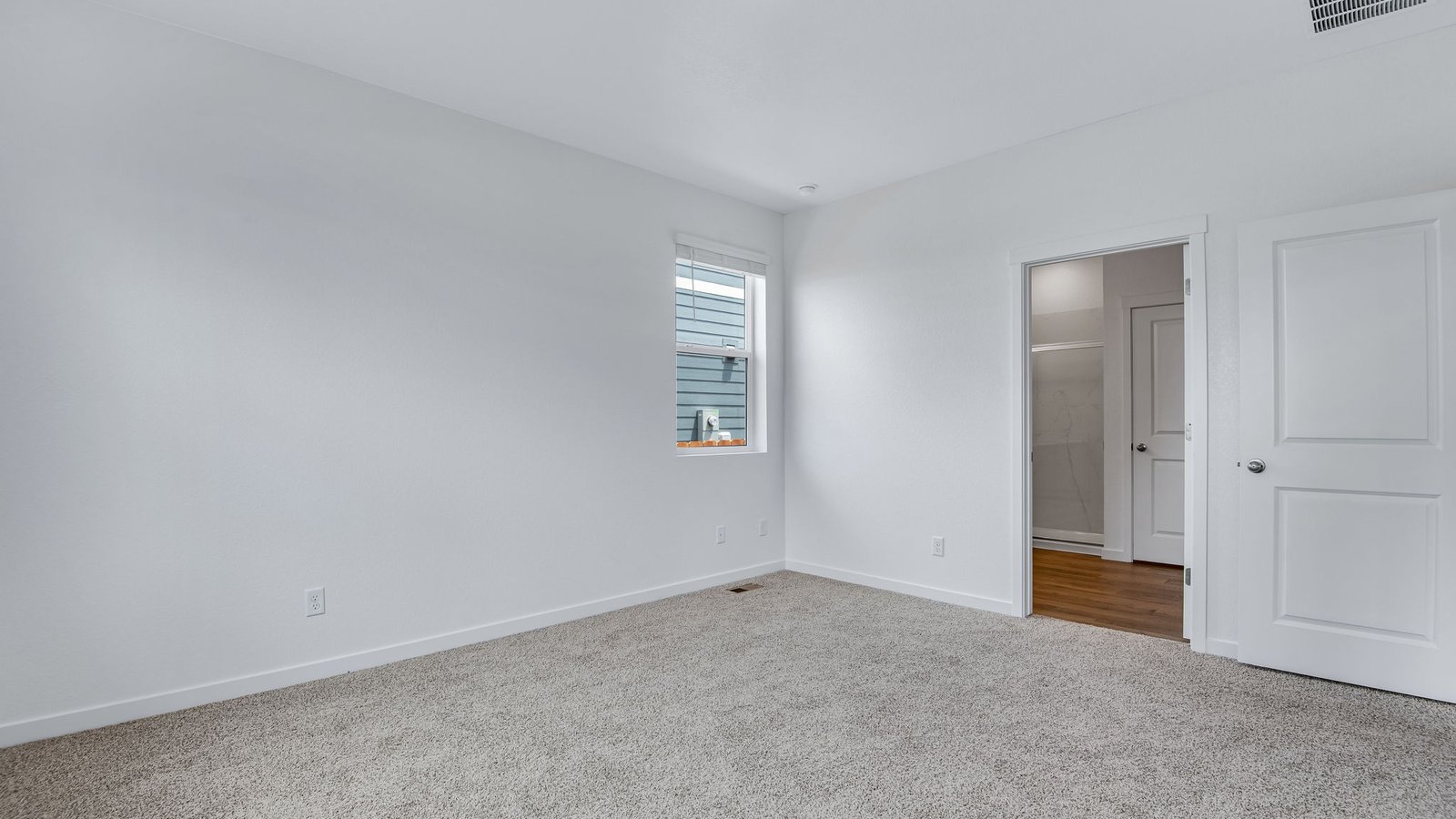 primary bedroom with natural light in new construction home fort lupton, co