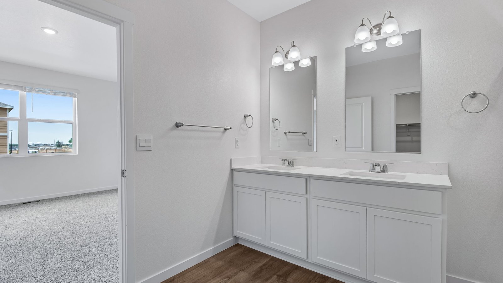 primary bath with white cabinets in new construction home fort lupton, co