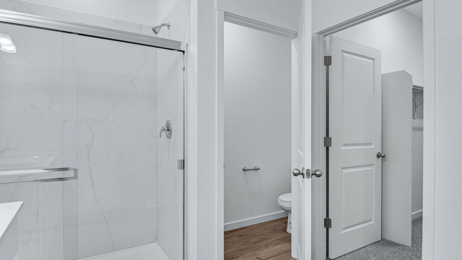shower and walk-in closet in primary bathroom fort lupton, co home