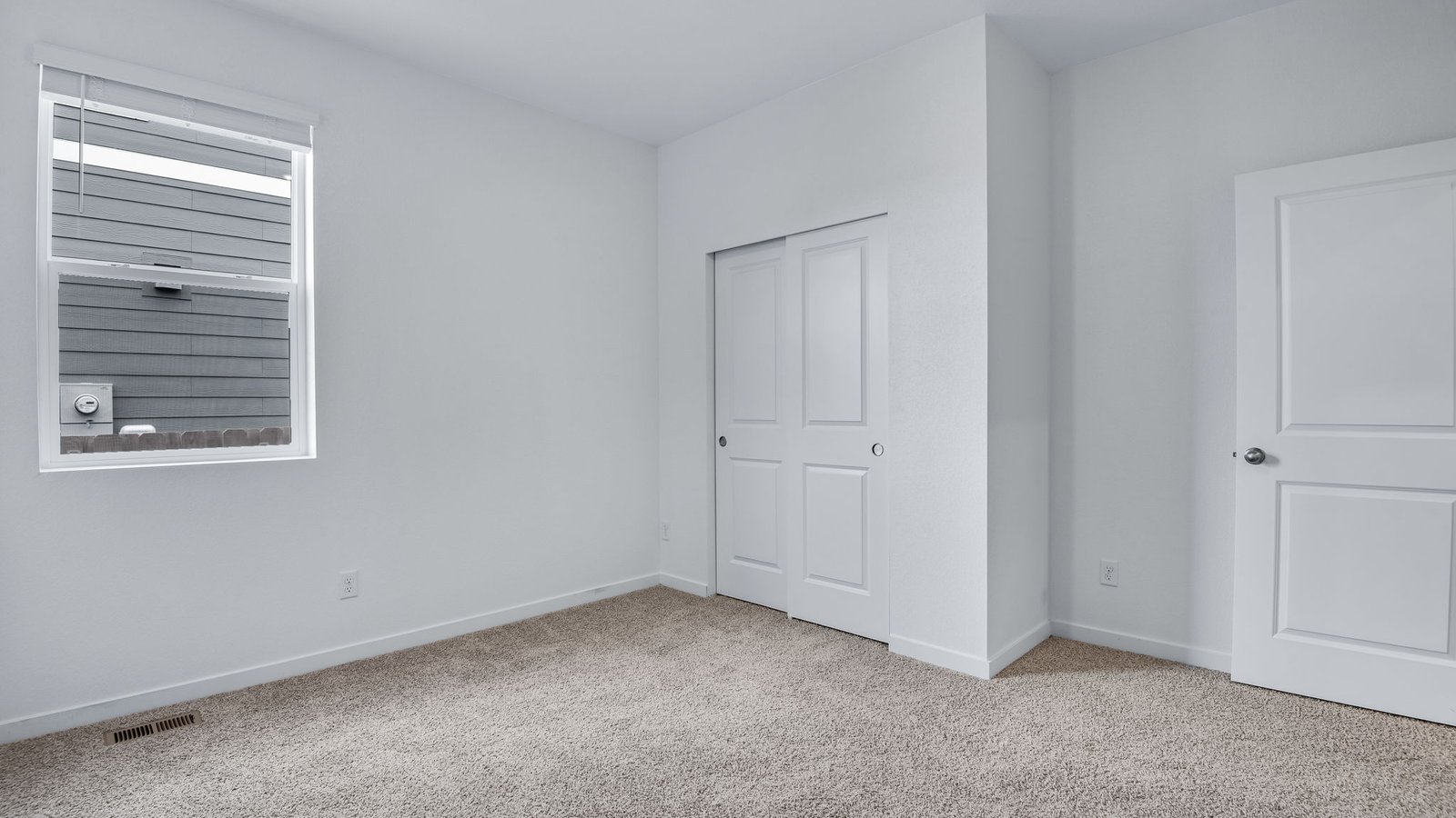 third bedroom with window in new fort lupton home