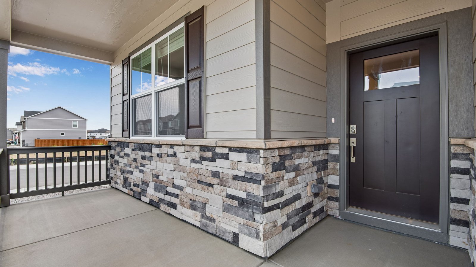 front porch and entry to new construction home in fort lupton, co