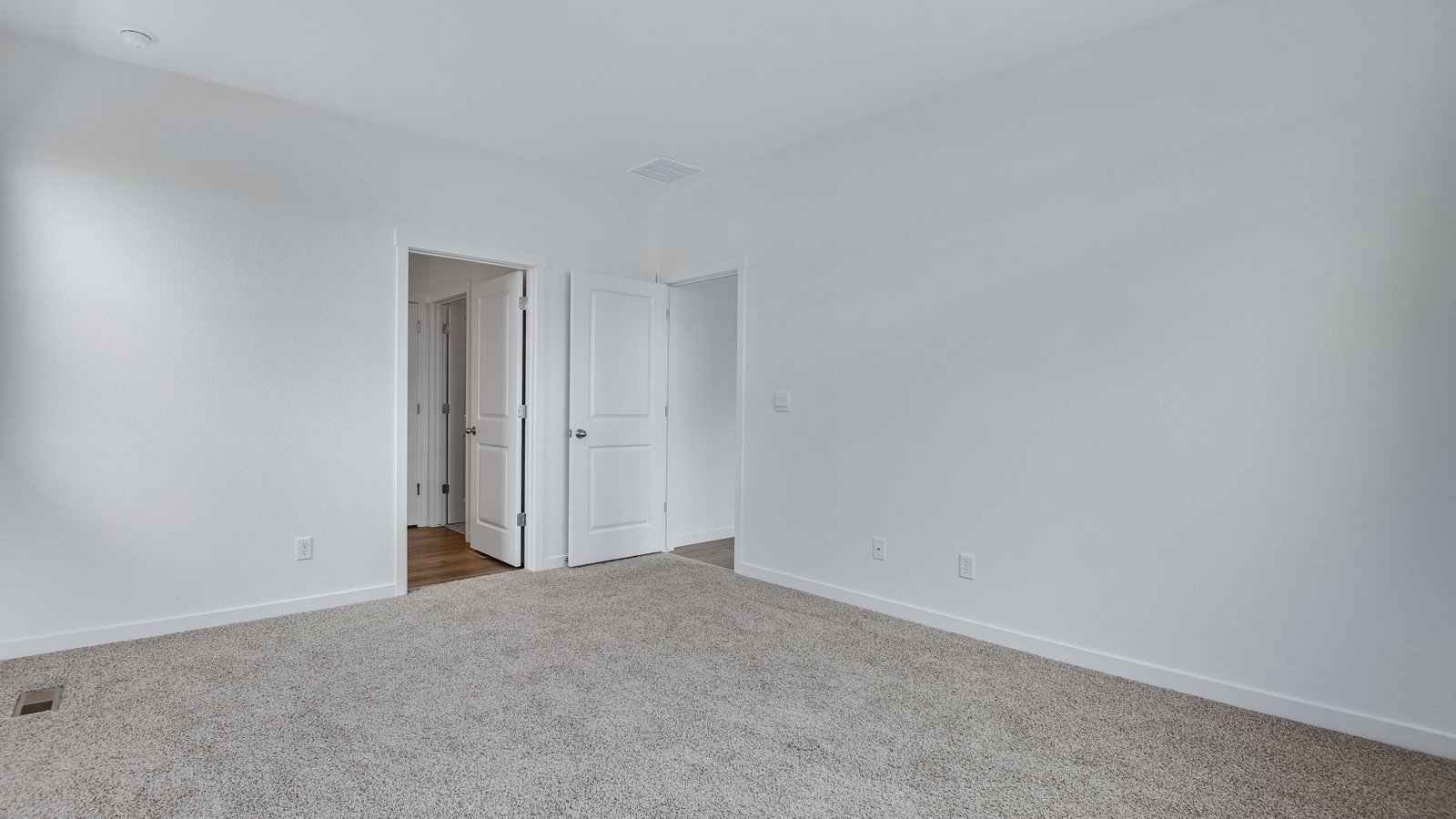 Primary bedroom with attached bathroom in Chatham floor plan at Vista Meadows community