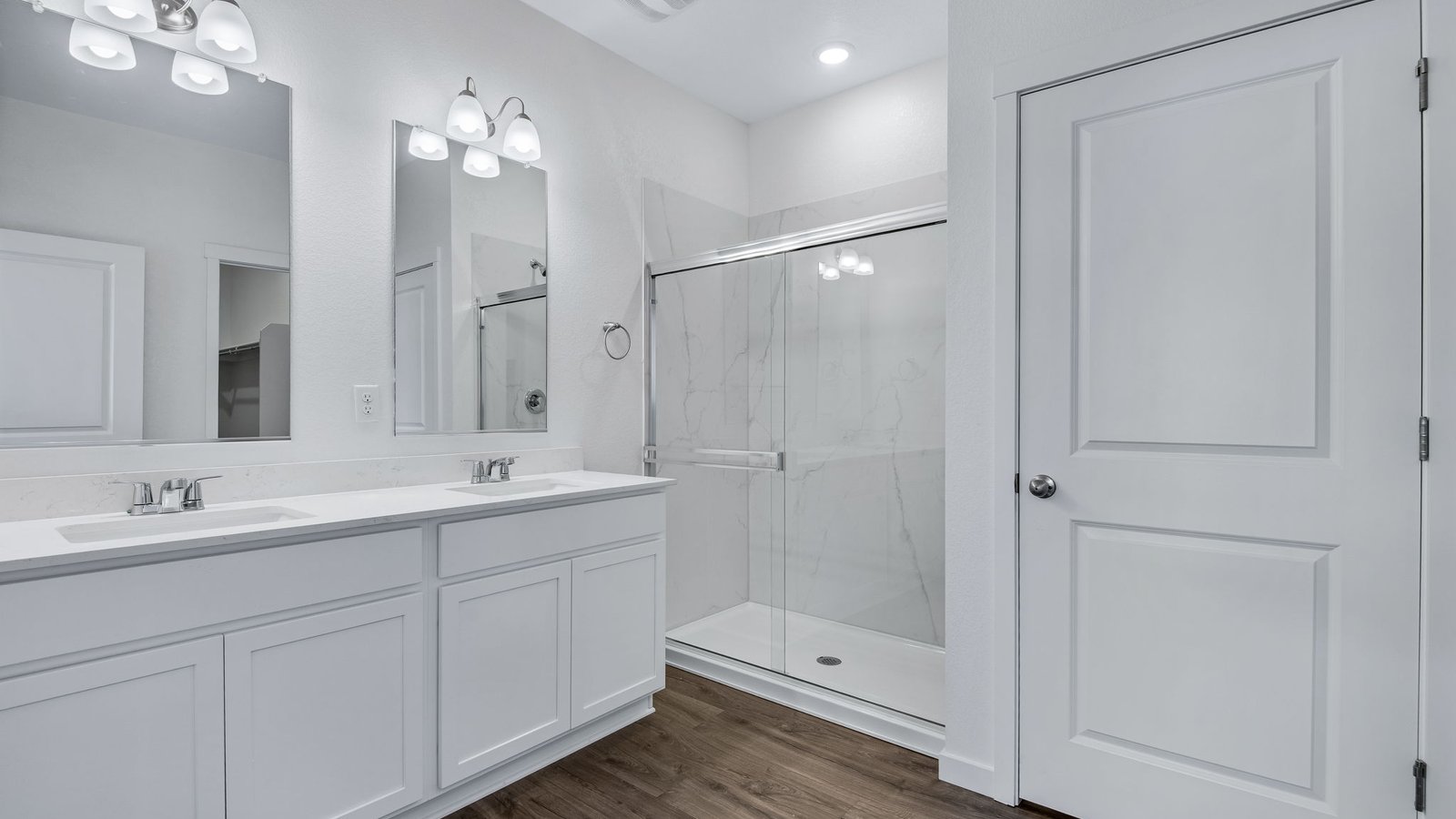 Dual sink vanity in private primary bathroom at Vista Meadows community