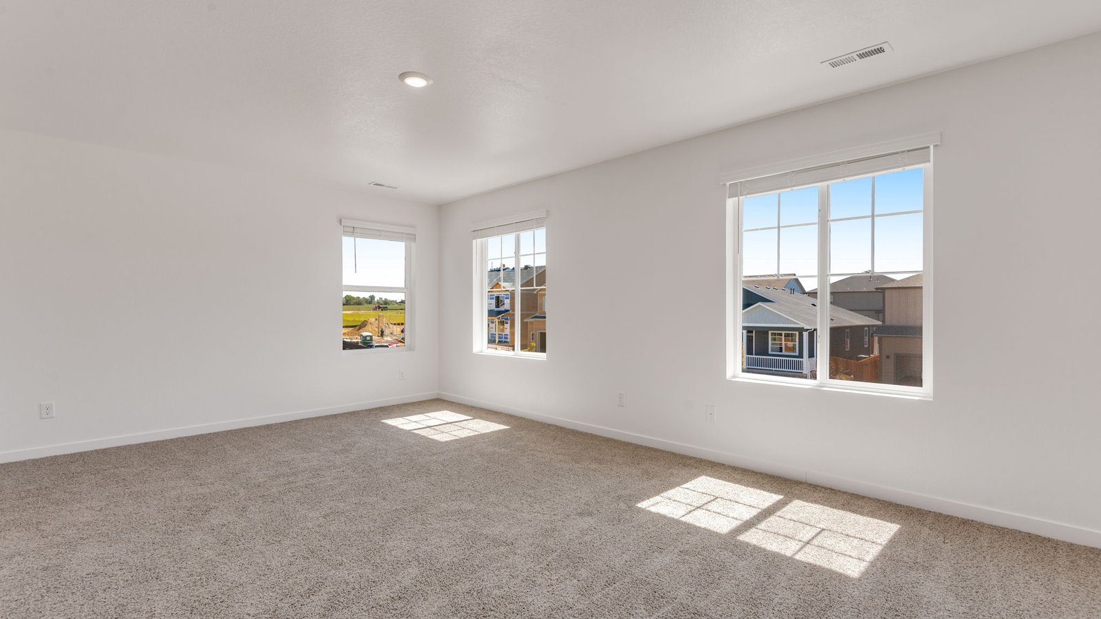 Spacious primary bedroom with large windows in new Vista Meadows Community in Fort Lupton
