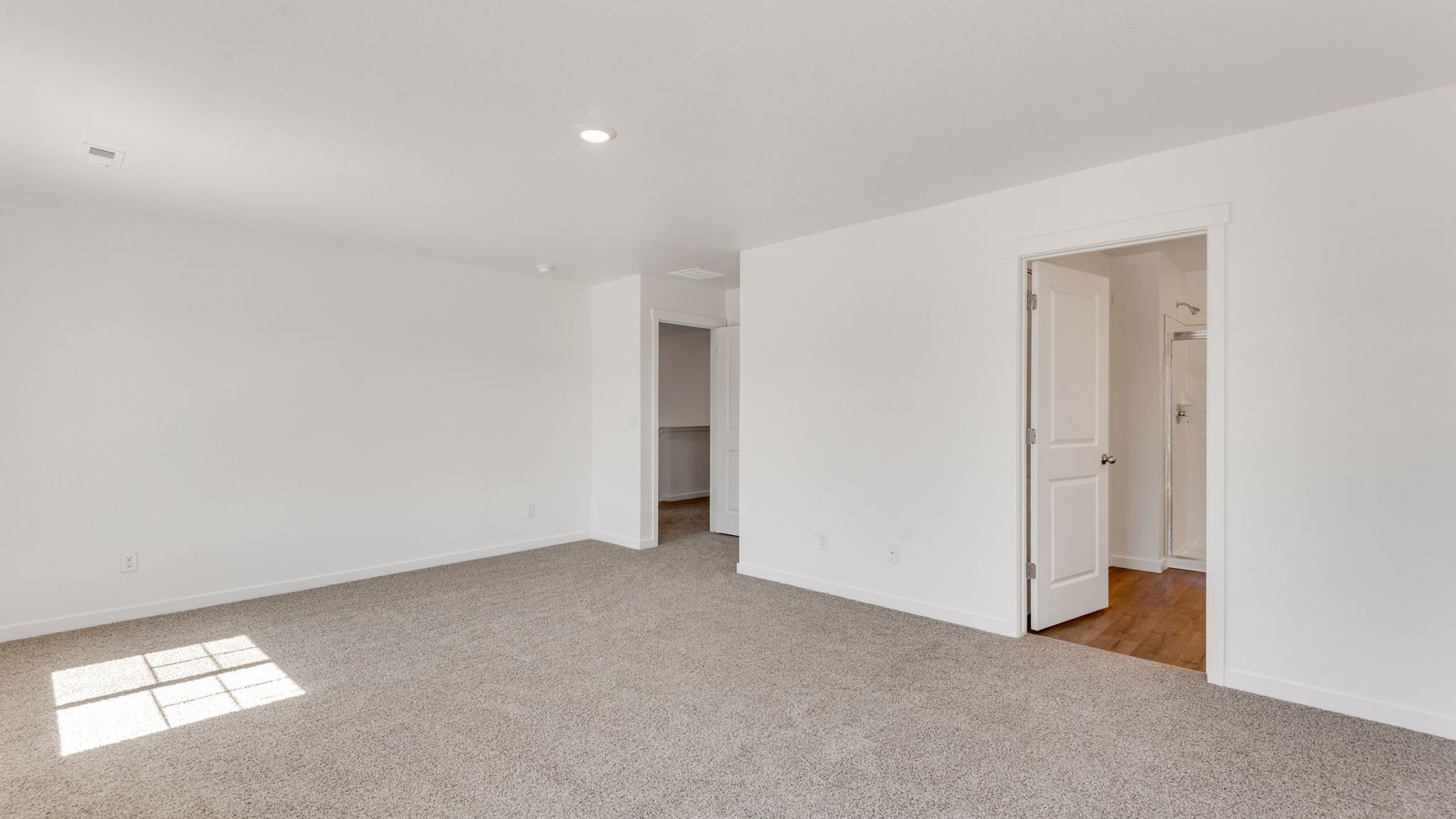 Spacious primary bedroom with natural light in new home at Vista Meadows community